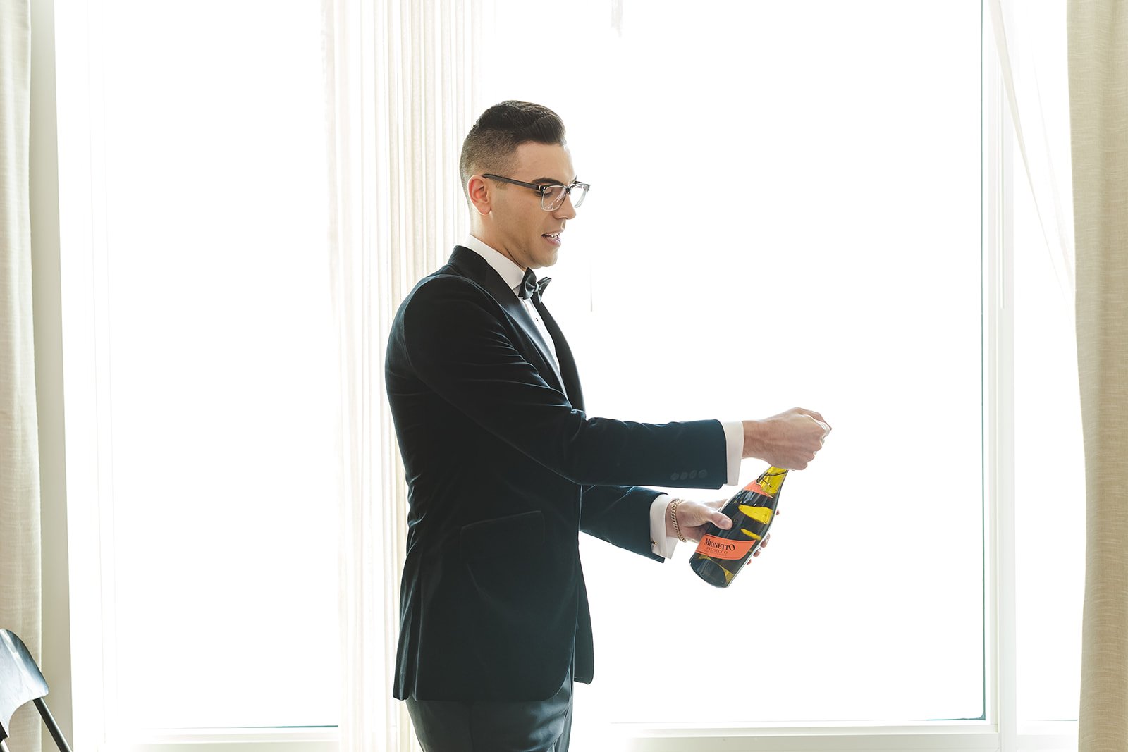 Groom popping champagne on wedding day  Earth to Table  Hamilton, ON  Fedora Media.jpg