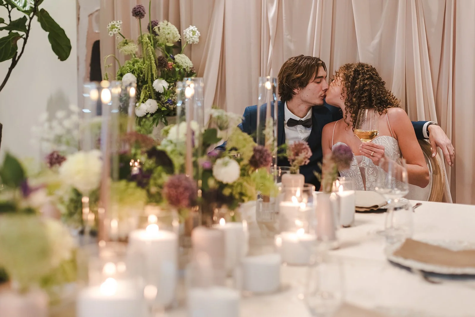 Bride and groom kiss holding .jpg