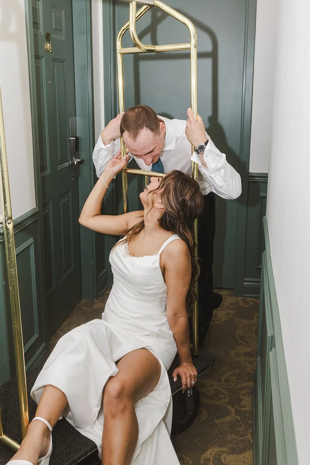 Bride and groom on luggage cart  River's Edge  Arlington Hotel  Paris, ON  Fedora Media.jpg