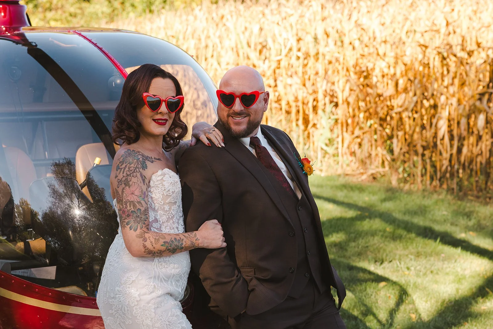Bride and Groom wearing heart shaped sunglasses in front of helicopter  Great Lakes Helicopters  Fedora Media.jpg