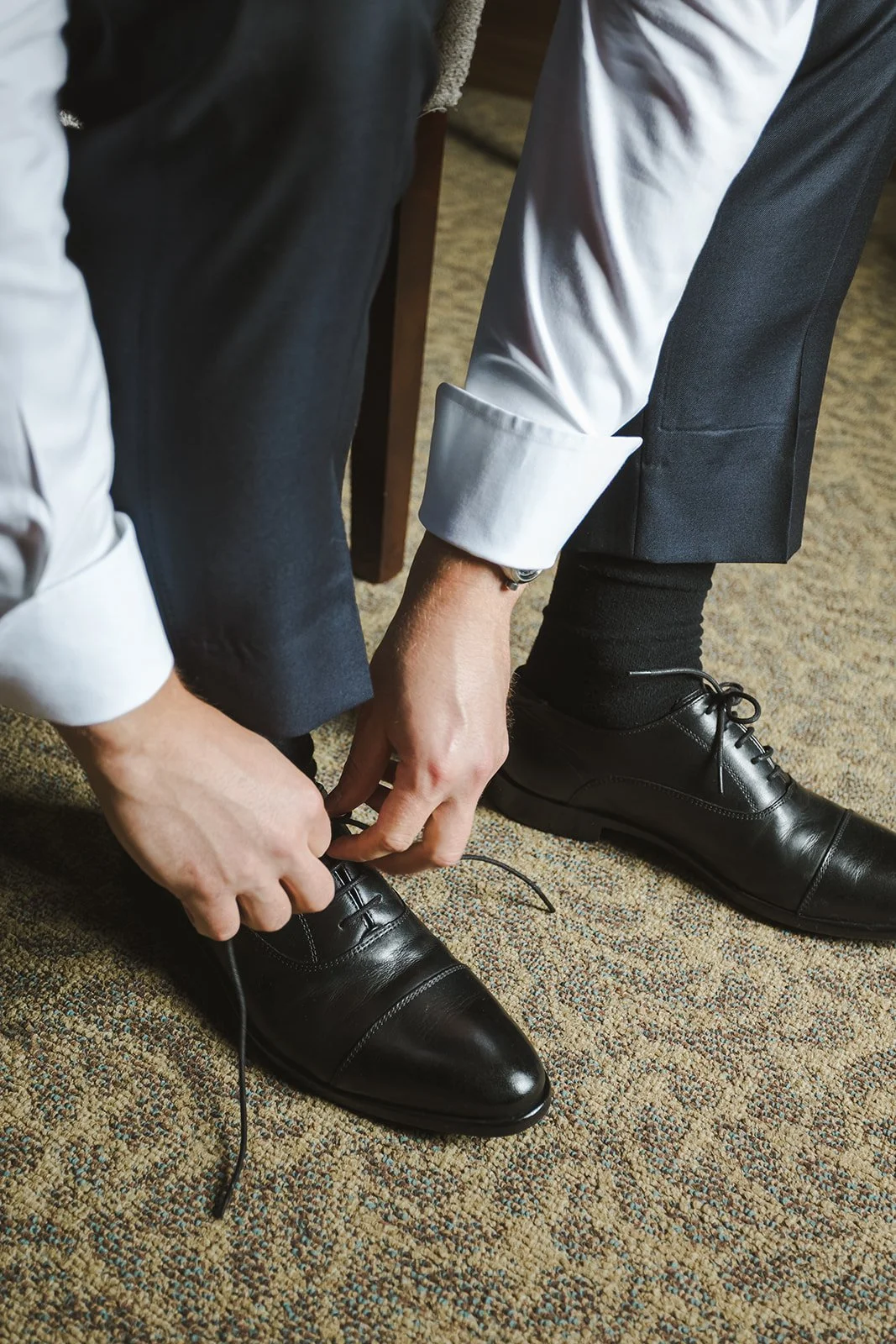 Groom tying shoe  River's Edge  Arlington Hotel  Paris, ON  Fedora Media.jpg