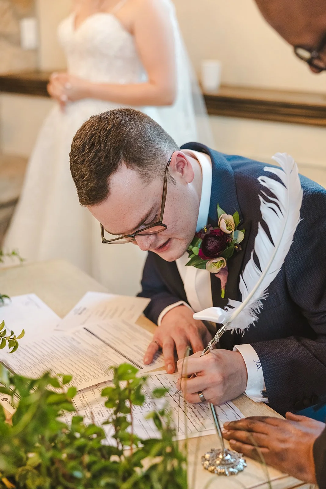 Groom signing wedding certificate  Ancaster,  ON  Ancaster Mill  Fedora Media.jpg