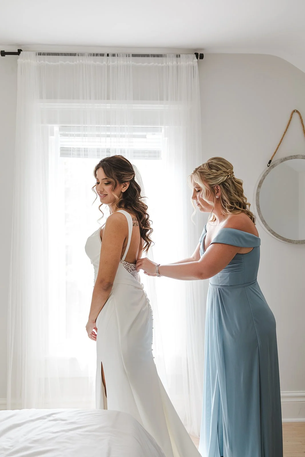 Maid of honour zipping up bride's dress  River's Edge  Arlington Hotel  Paris, ON  Fedora Media.jpg