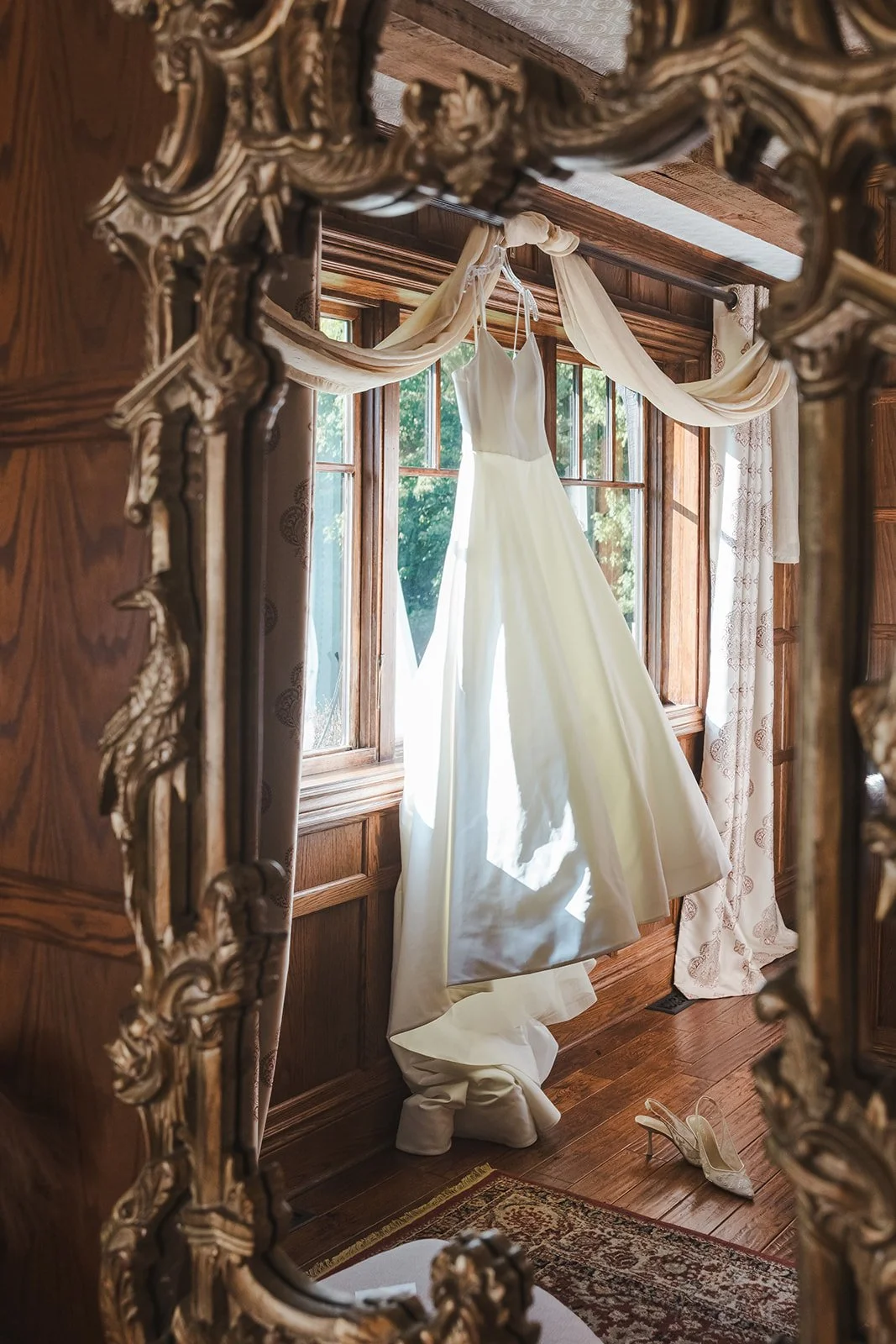 White wedding dress hanging in window  Erin Estates  Fedora Media.jpg