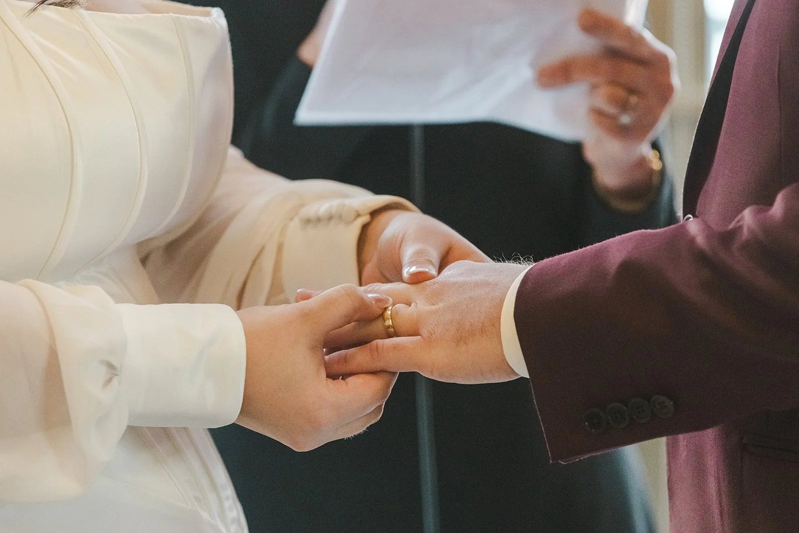 Bride placing ring on groom's finger  Lakeview By Carmens  Hamilton, ON  Fedora Media.jpg