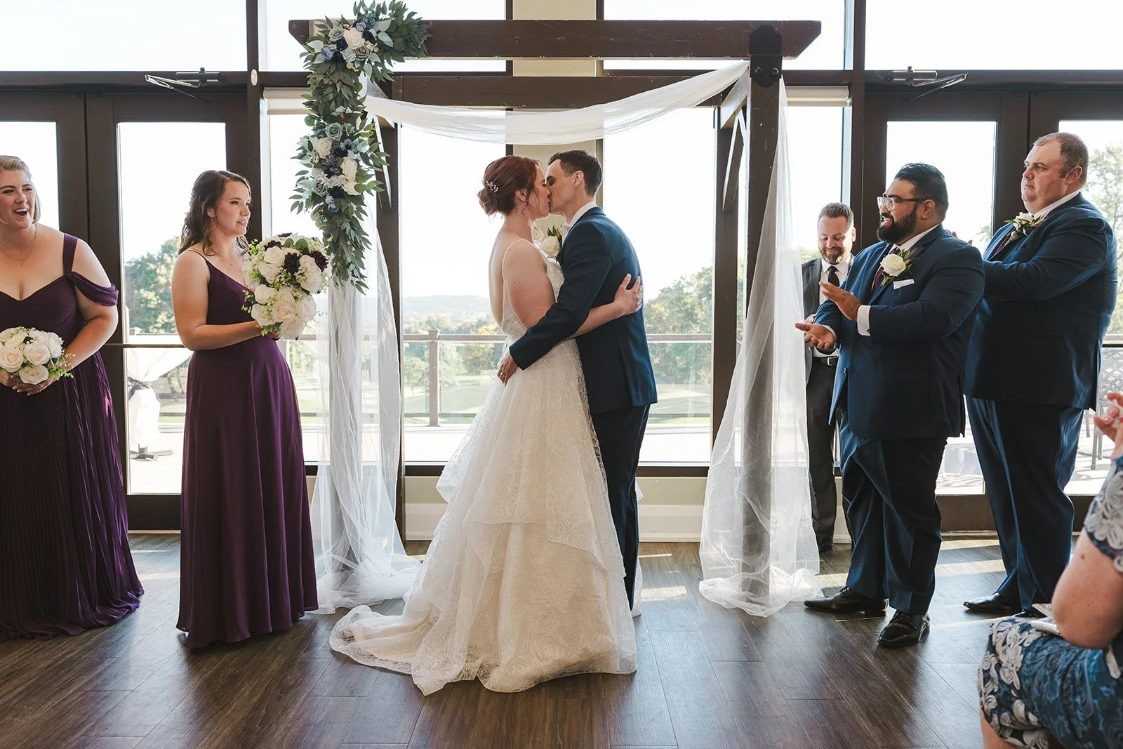 Bride and groom first kiss during wedding ceremony  Golf Course Wedding  Fedora Media.jpg
