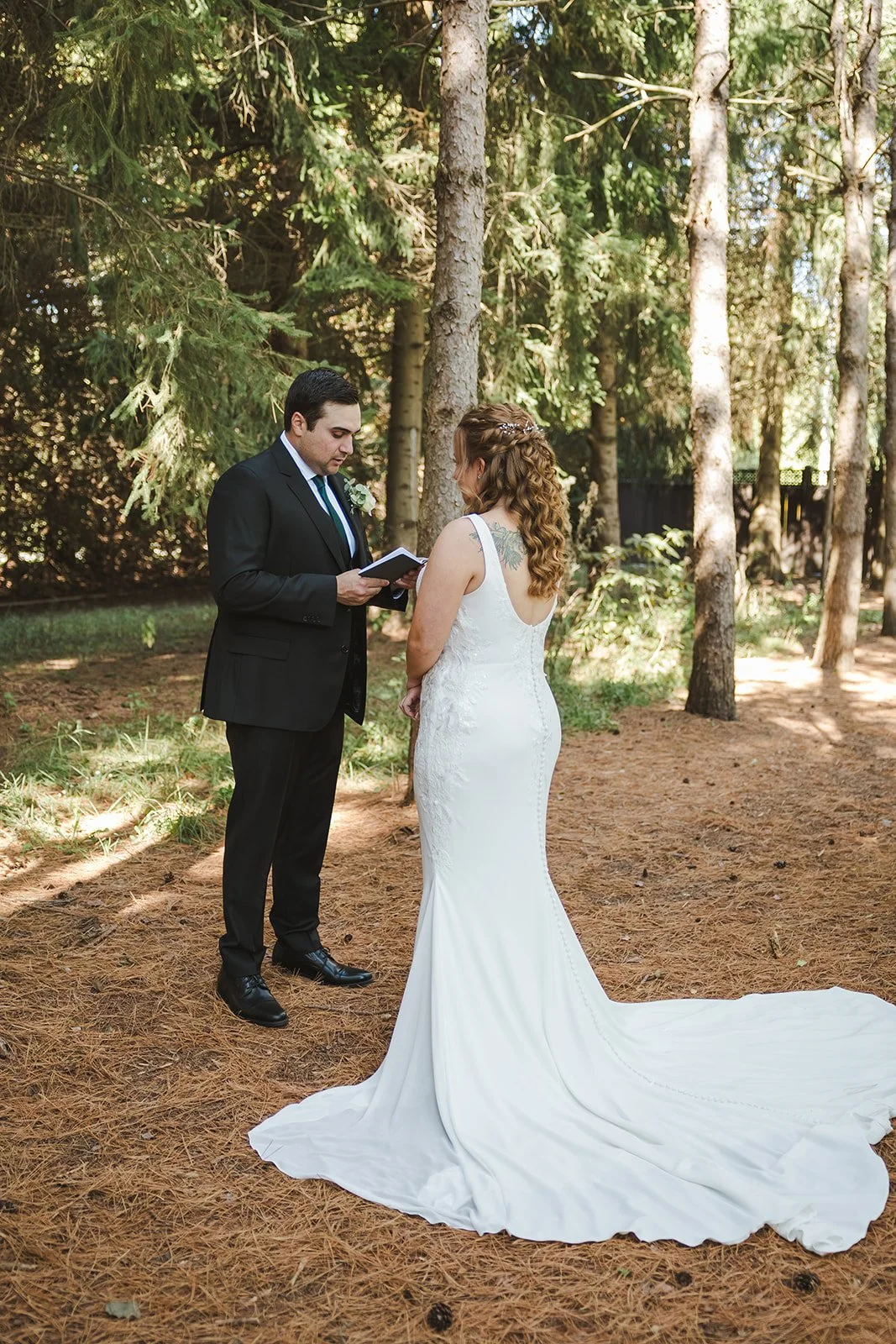 Groom reading vows in forest  Erin Estates  Fedora Media.jpg