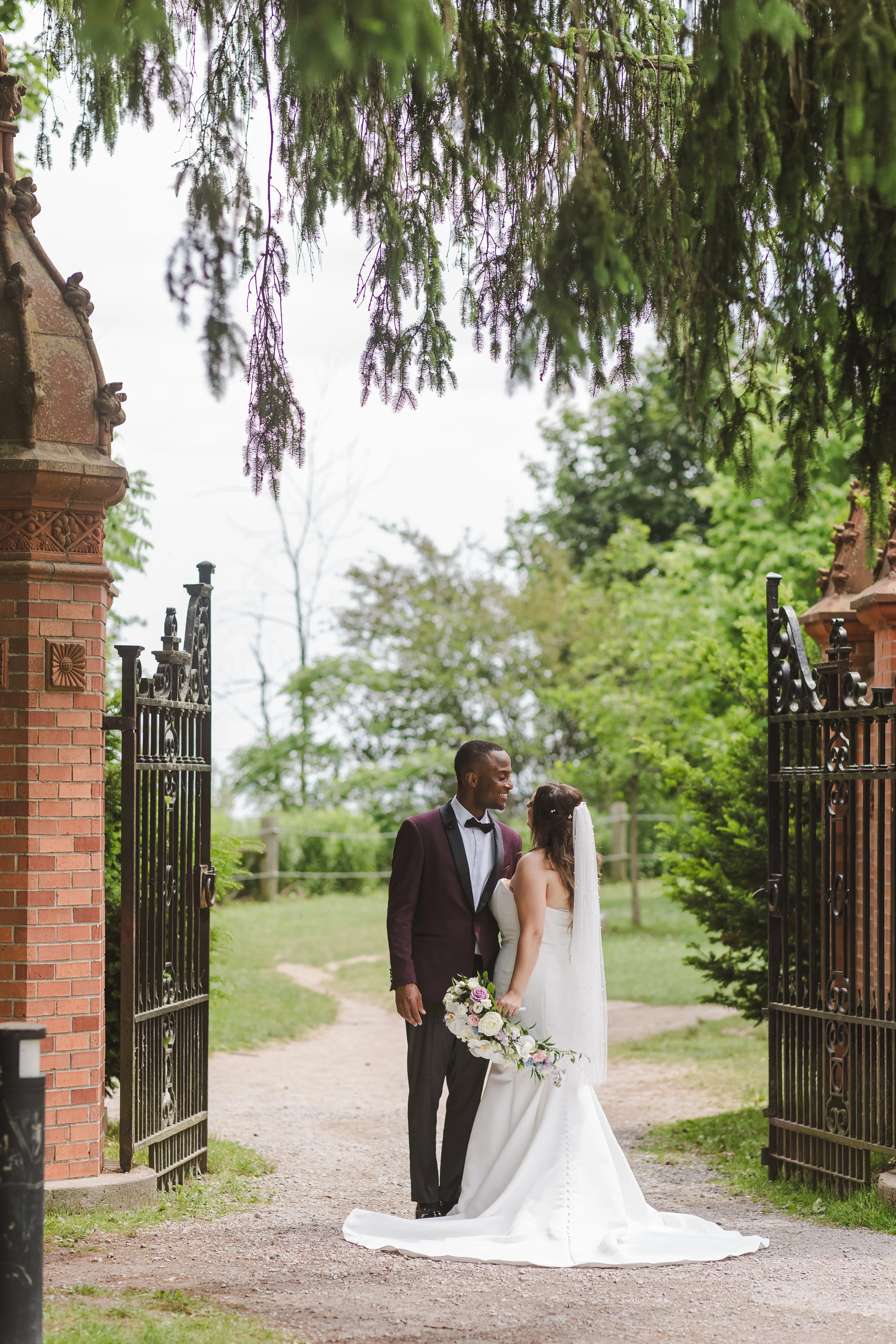 couple-standing-by-black-iron-fence-fedora-media.jpg