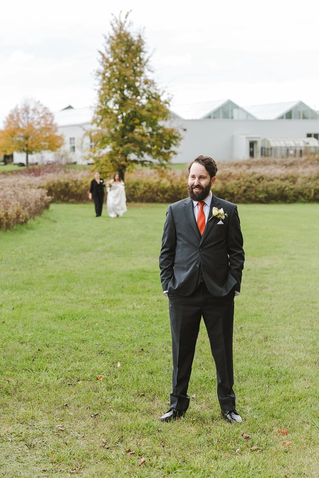 Bride walking up behind groom for first look on wedding day  Cambridge Butterfly Conservatory  Cambridge, ON  Fedora Media.jpg