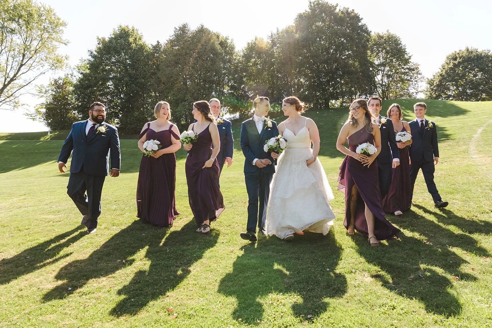 Bride and groom walking with wedding party  Golf Course Wedding  Fedora Media.jpg