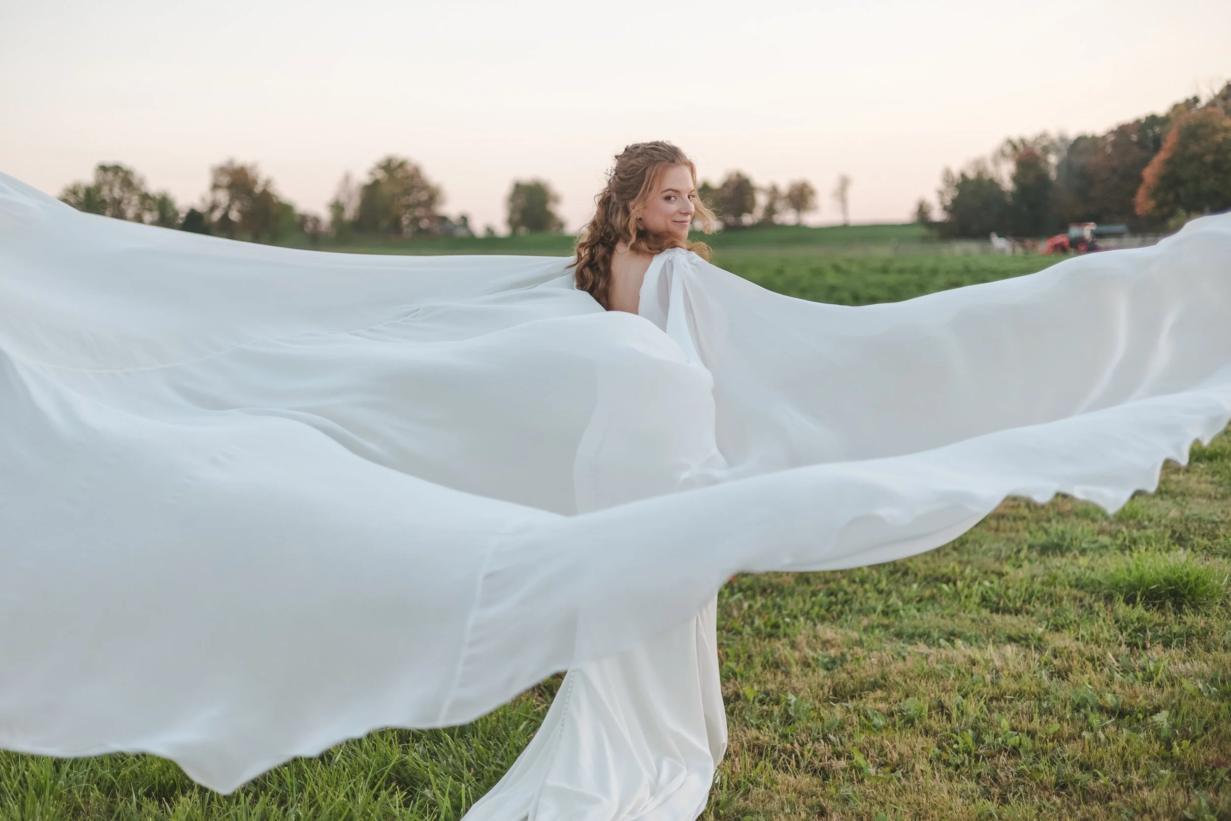 solo-bride-photo-with-cape-flowing-in-wind-fedora-media.jpg