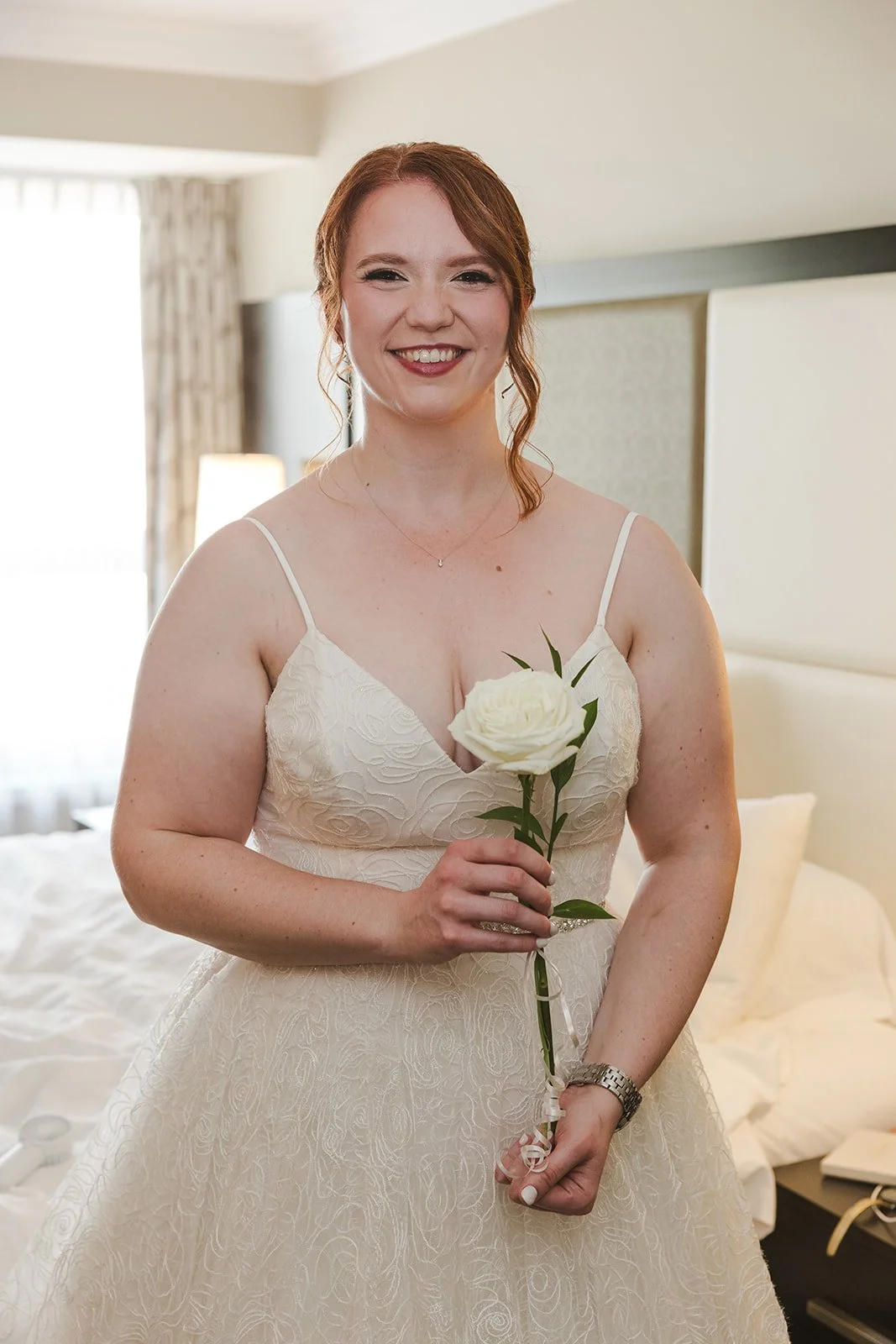 Bride in wedding dress holding single white rose  Golf Course Wedding  Fedora Media.jpg