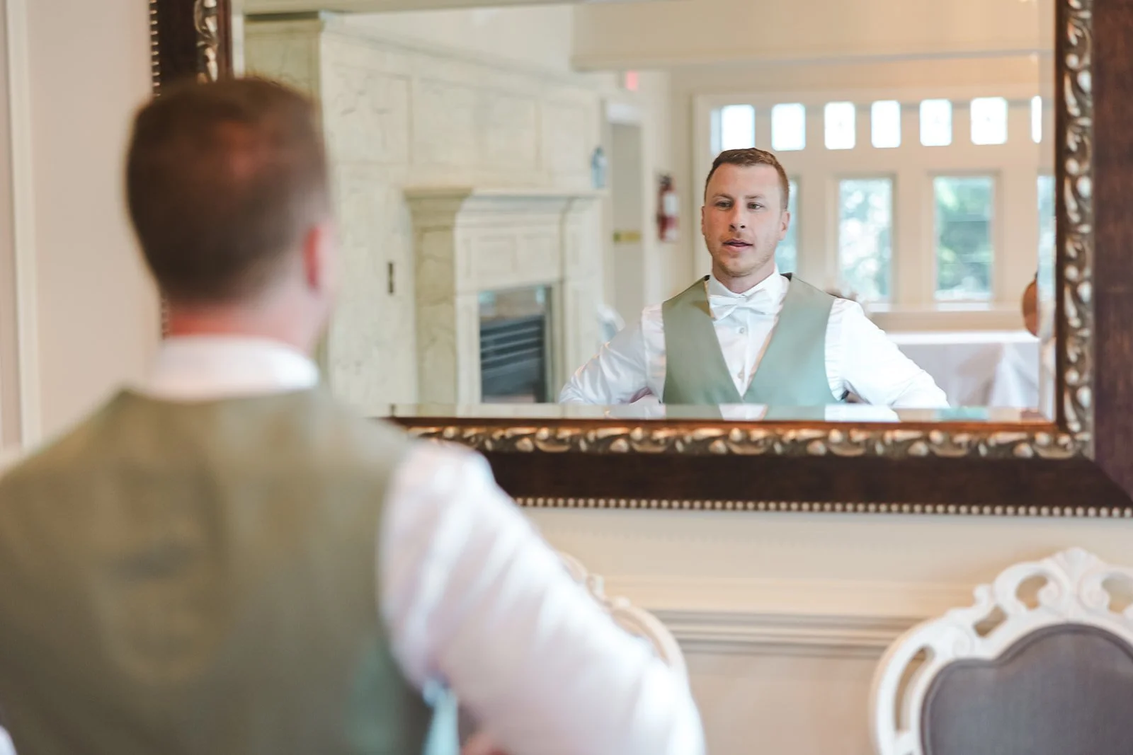 Groom checking himself in mirror  Hamilton, ON  Fedora Media.jpg