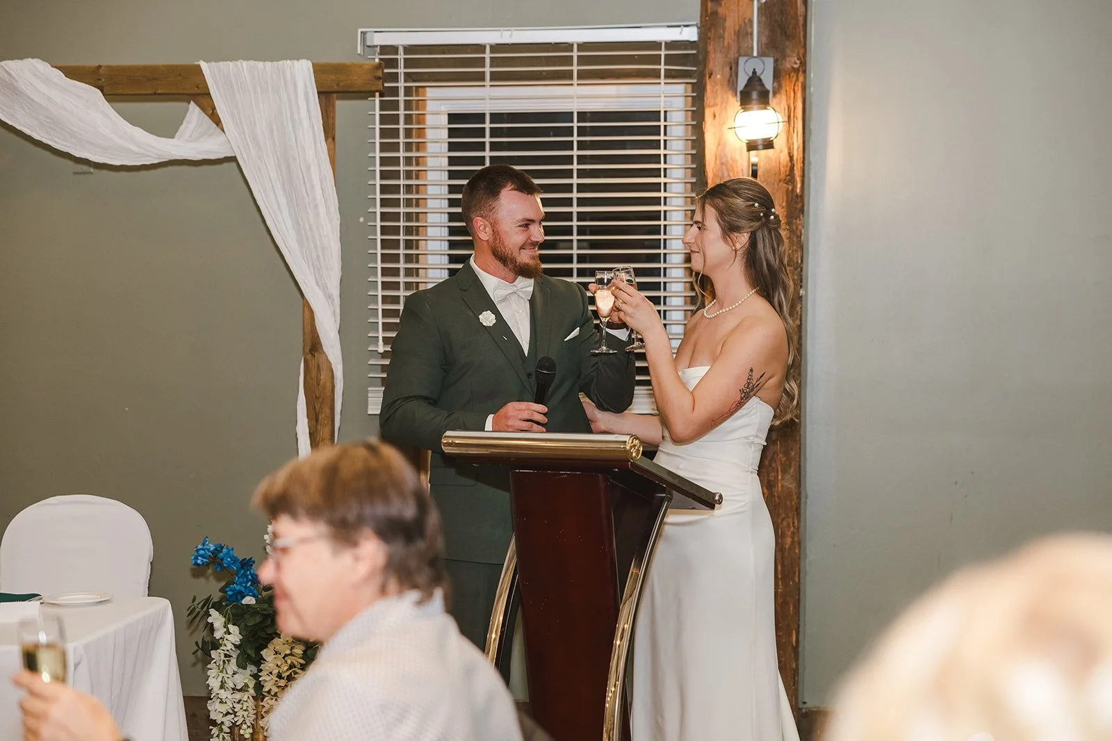 Bride and groom cheers during wedding speech  fall wedding  Fedora Media.jpg