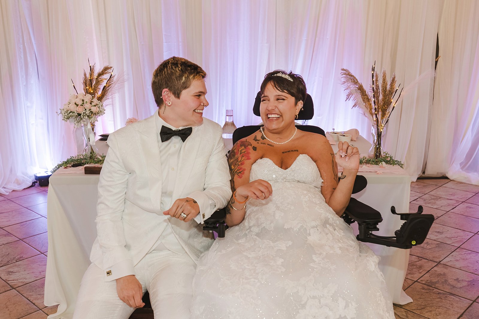 Brides laughing at head table  Pine Valley Chalet  Kitchener, ON  Fedora Media.jpg