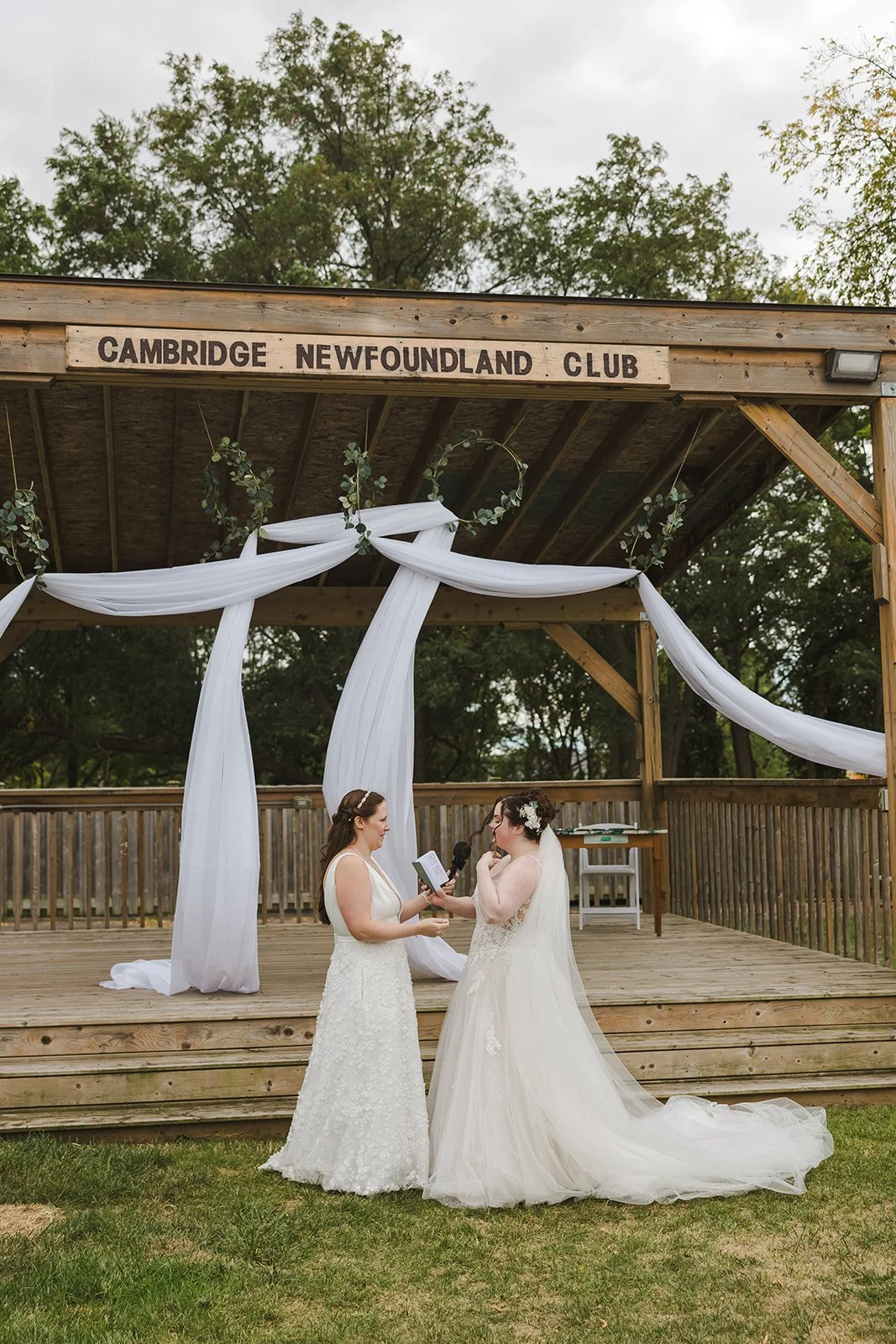 Brides exchanging vows during wedding ceremony  Newfoundland Club  Cambridge, ON  Fedora Media.jpg