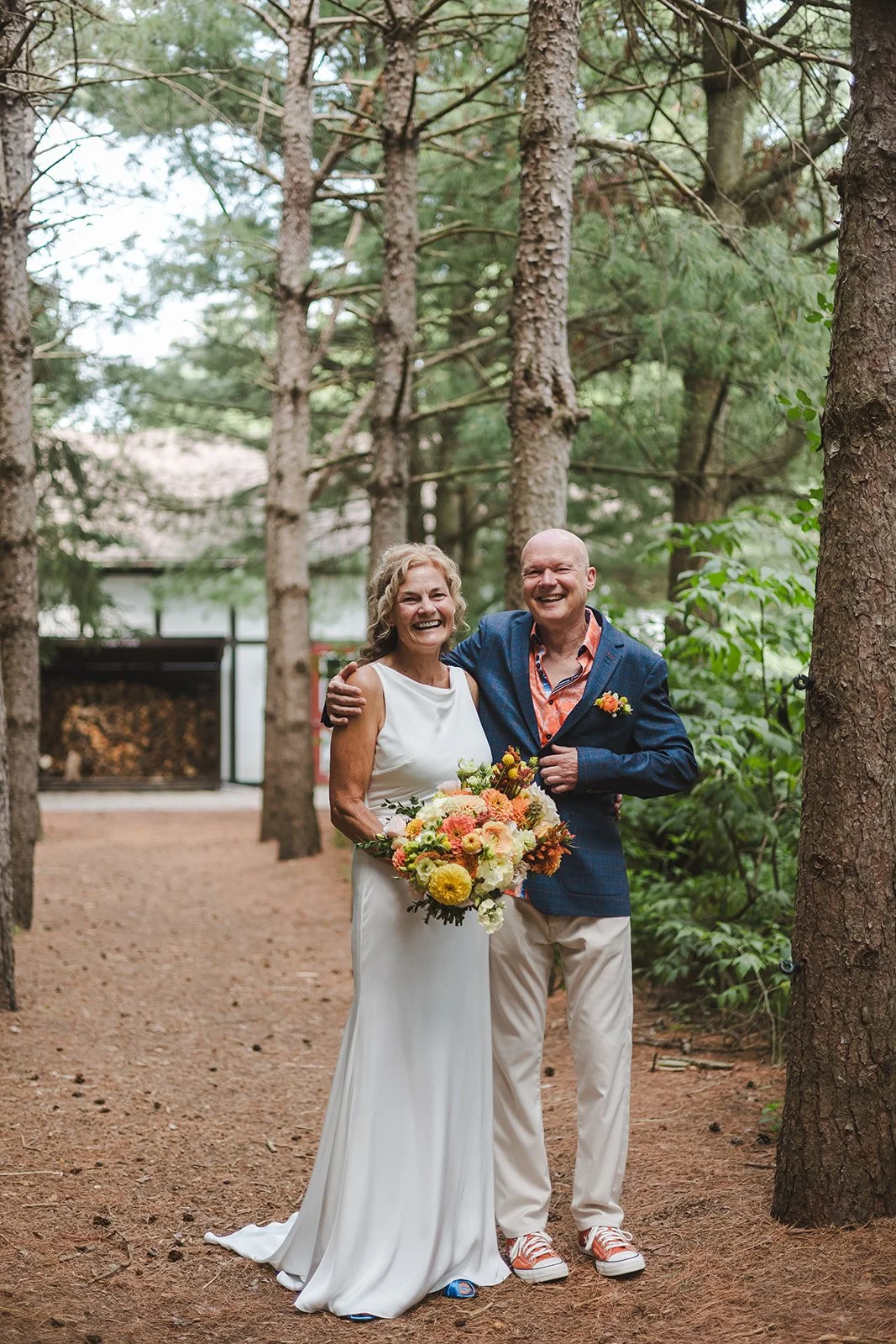 Bride and groom standing together in forest  Erin Estates  Fedora Media.jpg