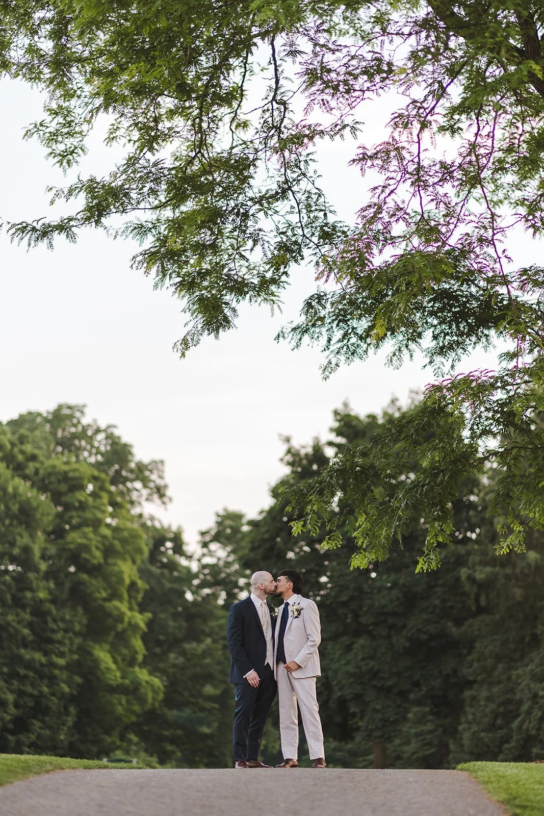 Grooms kissing on pathway  Dundas Valley  Fedora Media.jpg