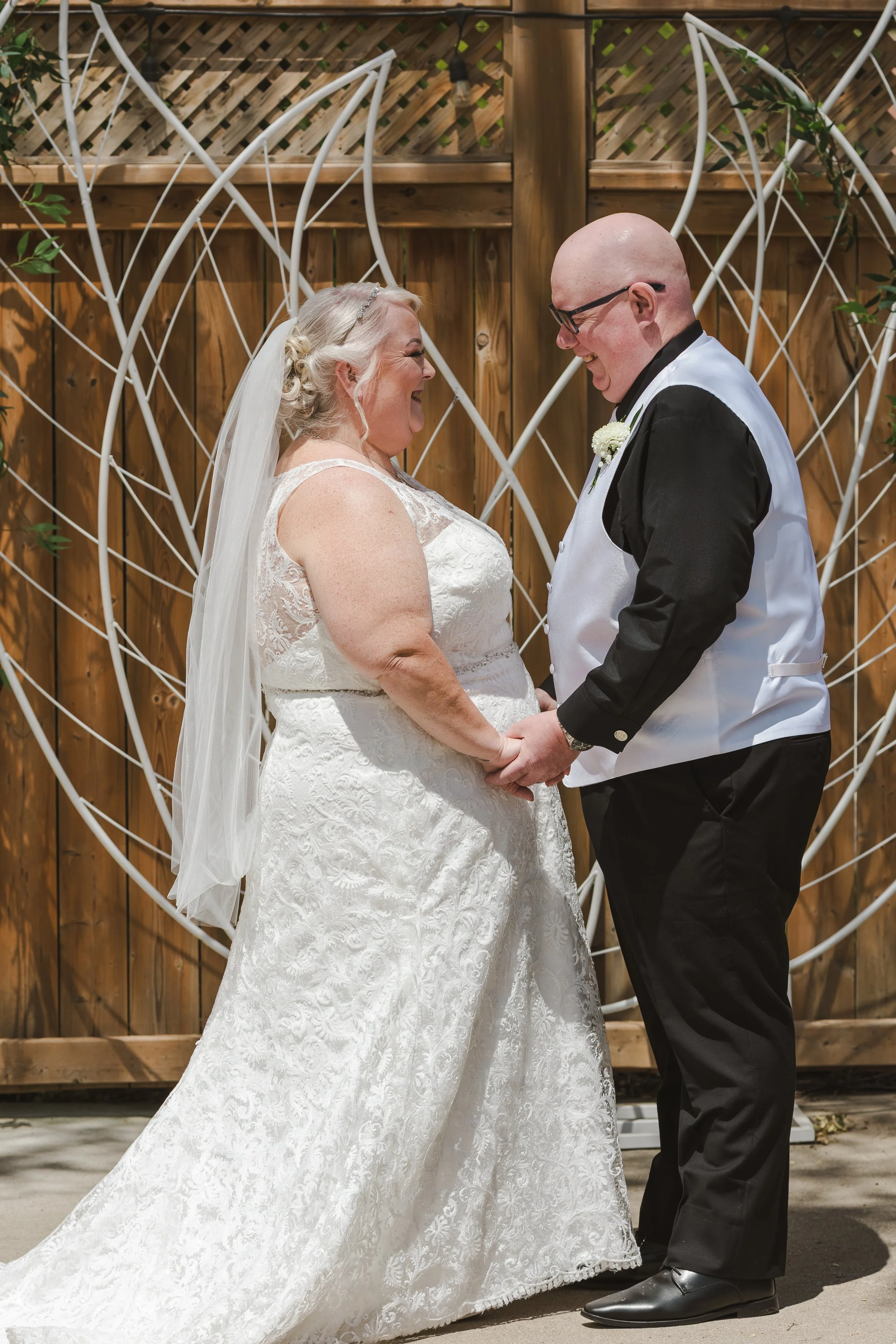 bride-and-groom-holding-hands-fedora-media.jpg