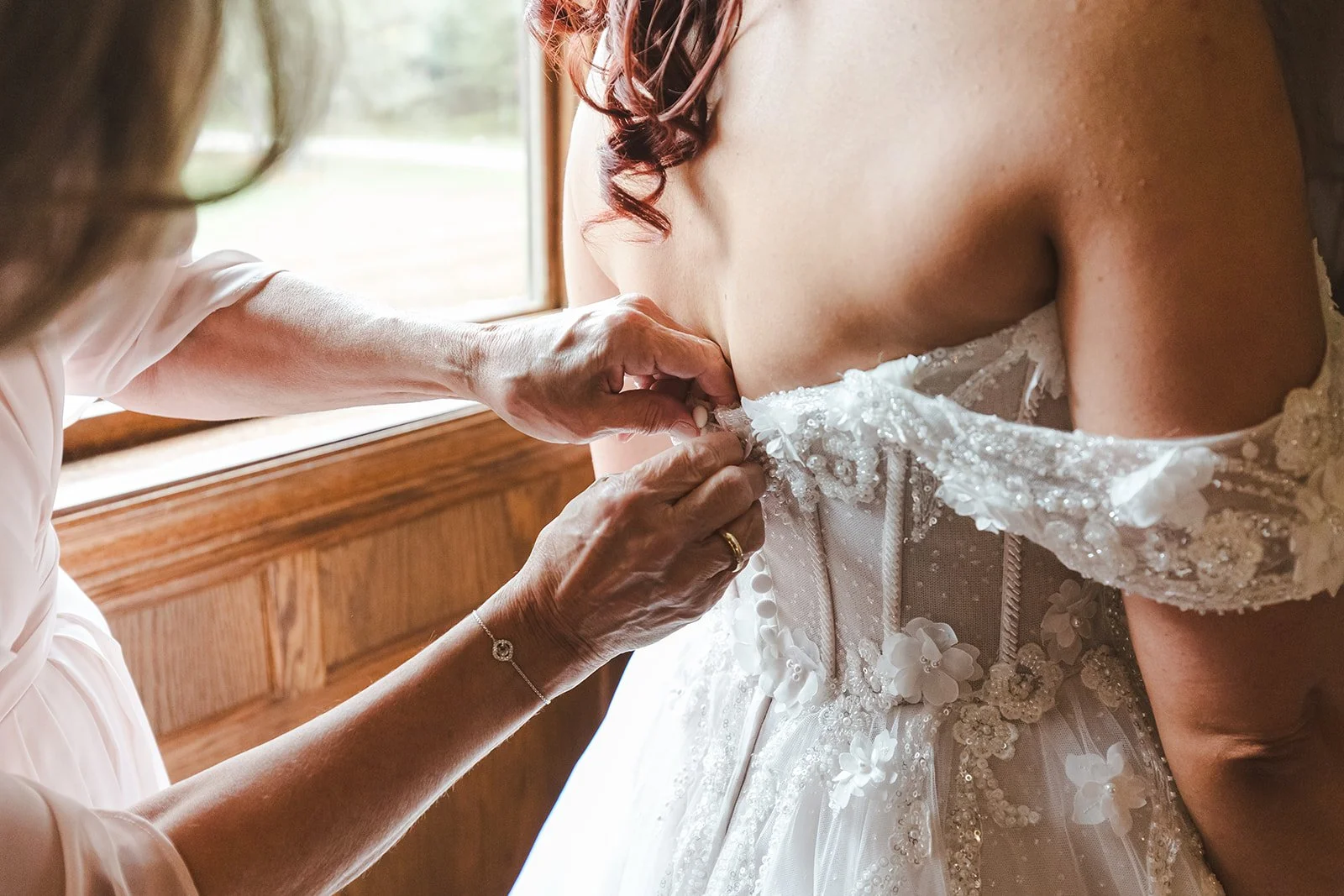 Bride's mother fastening button on dress  Erin Estates  Fedora Media.jpg