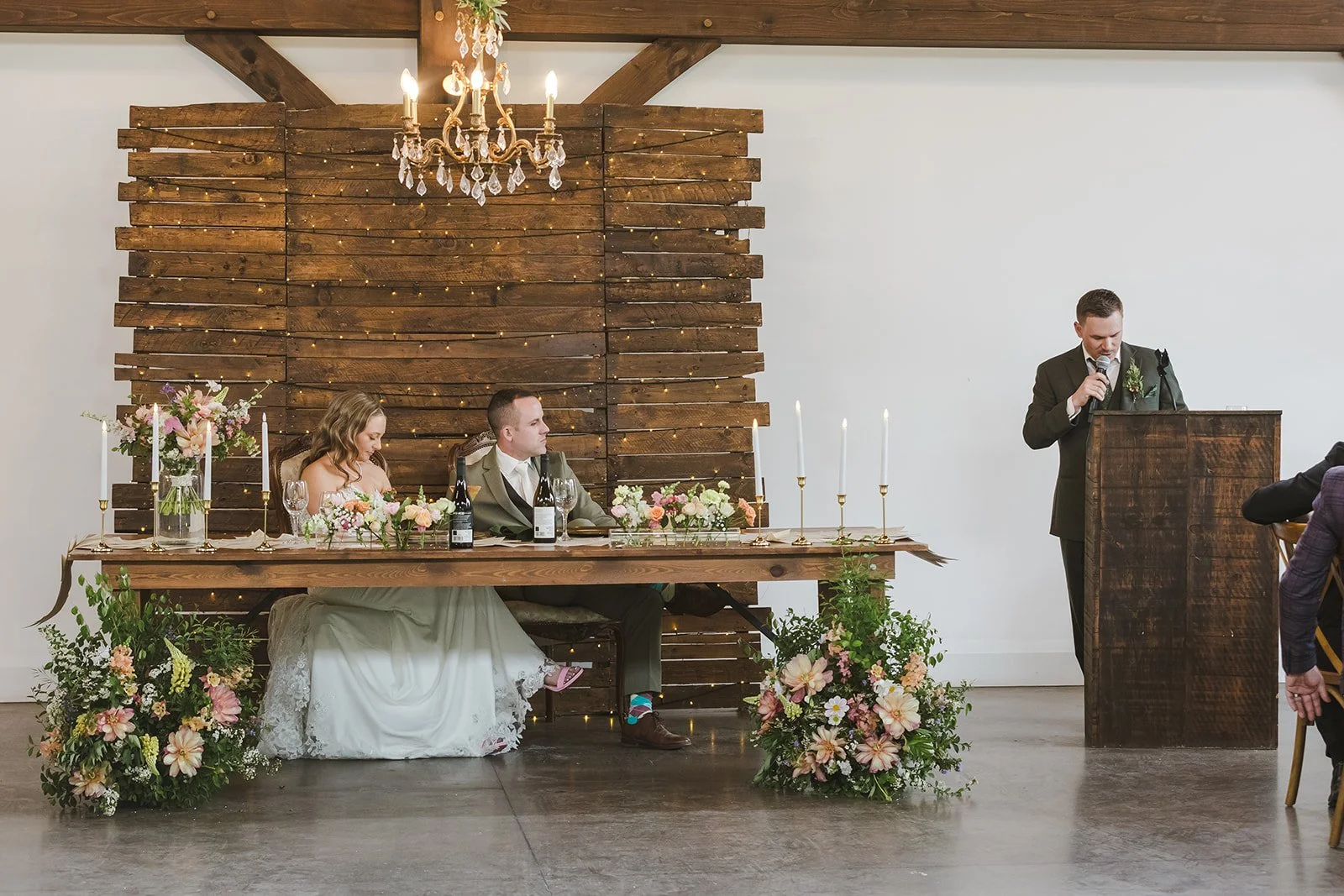 Bride and groom at head table watching speeches  Erin Estates  Fedora Media.jpg