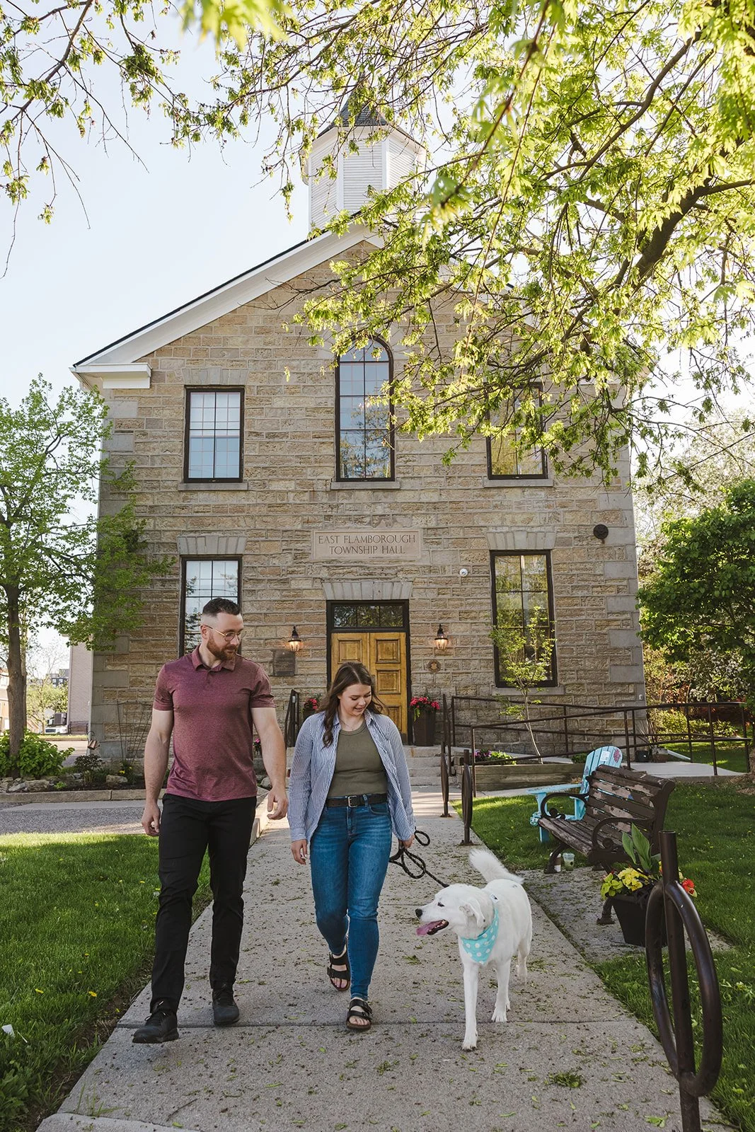 Couple walking dog in front of building  Ontario Engagement  Fedora Media.jpg