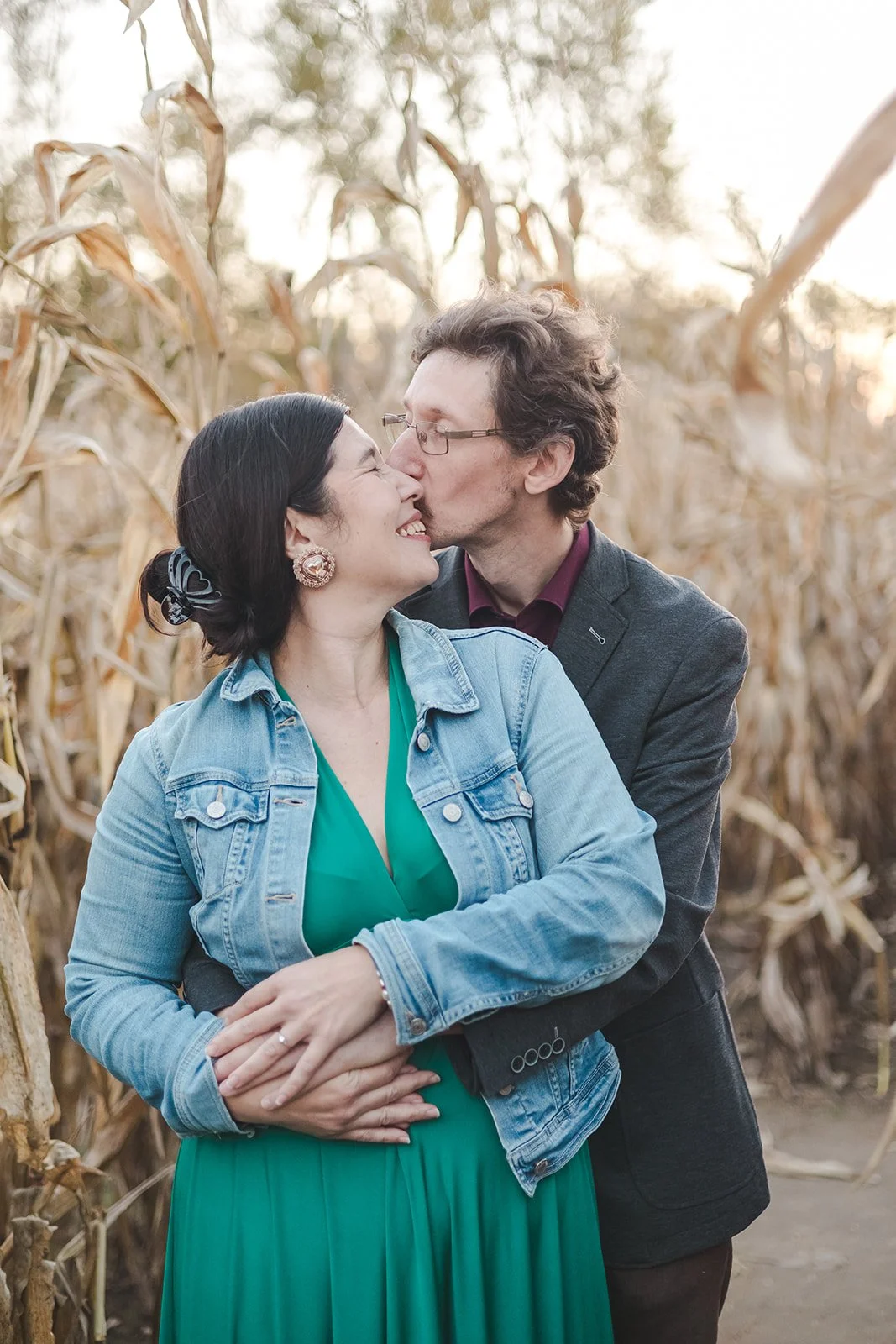 Man kissing woman on cheek in corn field  Ontario Engagement  Fedora Media.jpg
