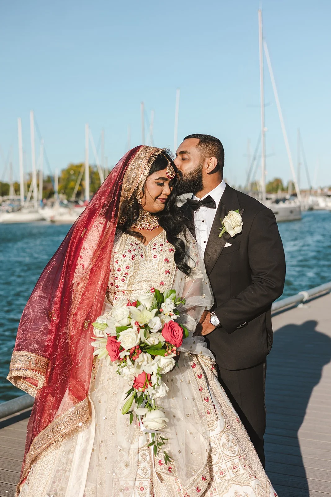 Groom kisses brides forehead  Hamilton, ON  Royal Hamilton Yacht Club  Fedora Media .jpg