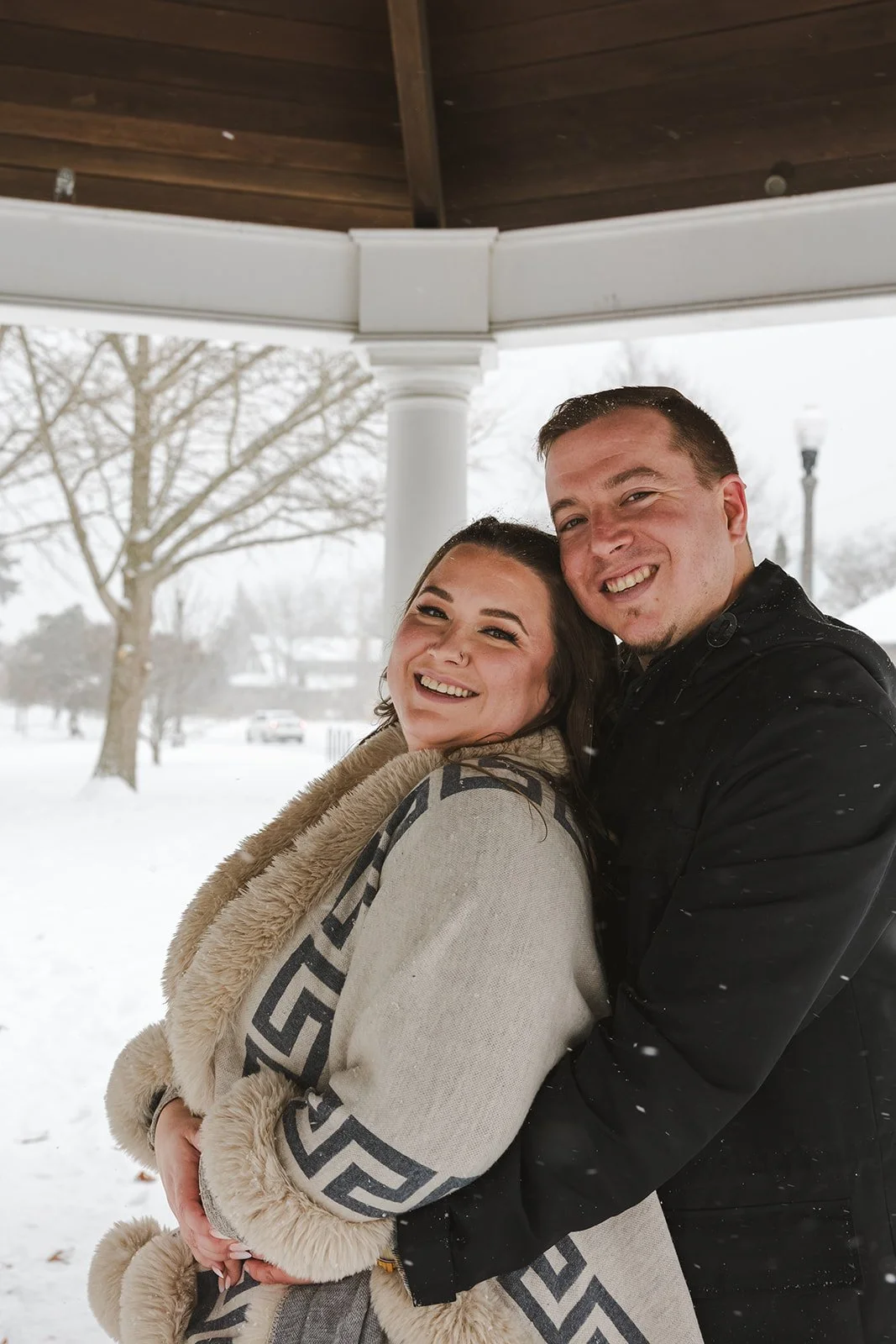 Couple smile and embrace under gazebo  Ontario Engagement  Fedora Media.jpg