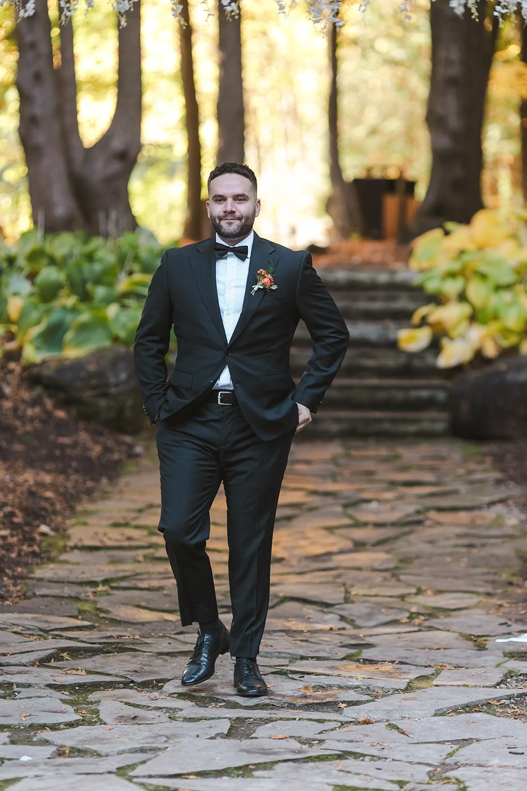 Groom walking down forest path  Erin Estates  Fedora Media.jpg