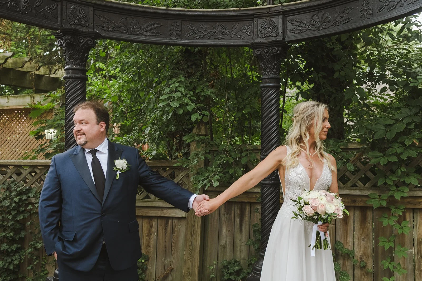 Bride and groom holding hands looking away from each other  London, ON  Fedora Media.jpg
