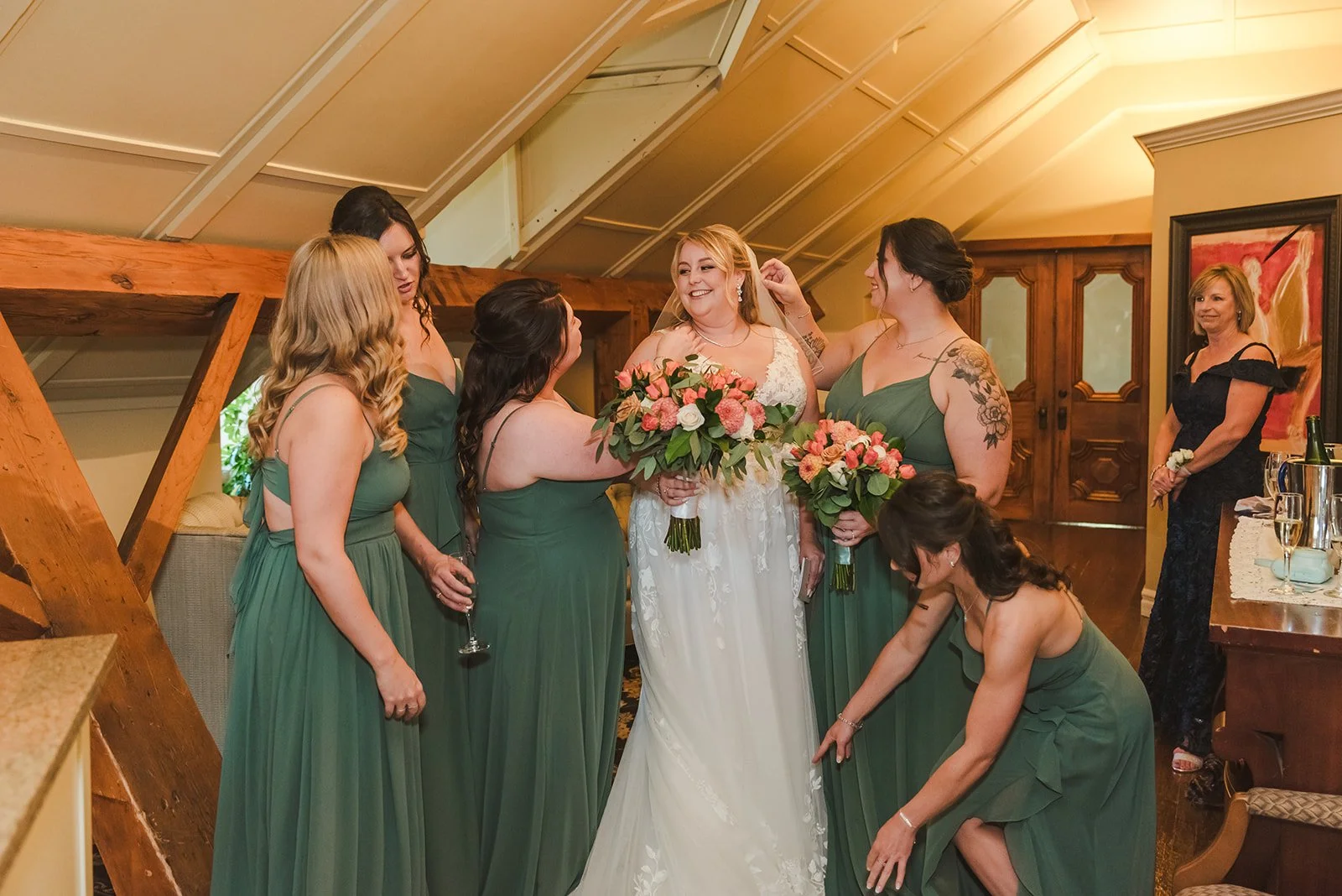 Bridesmaids help bride adjust dress  Ancaster,  ON  Ancaster Mill  Fedora Media.jpg