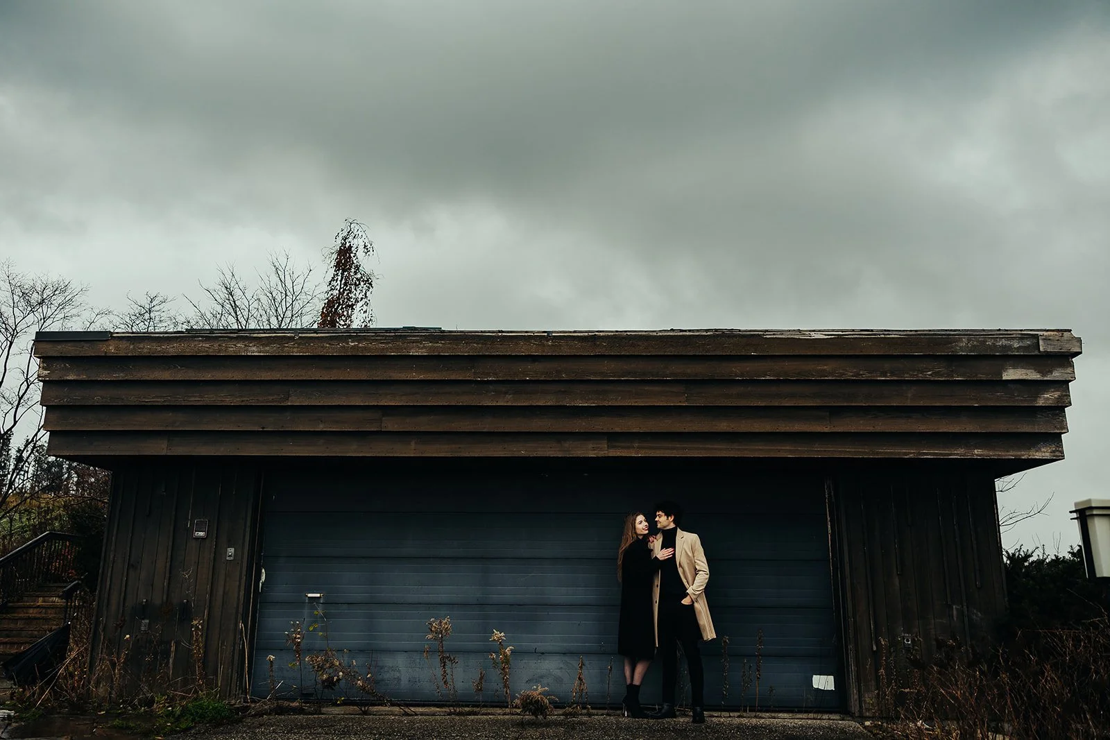 Engaged coupe embrace in front of building   Fedora Media.jpg