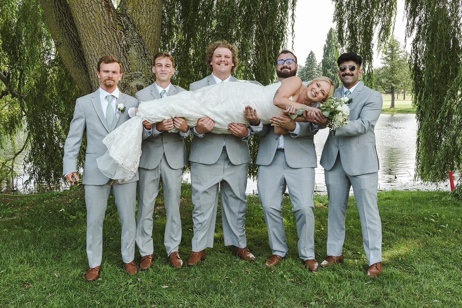 Groomsmen lifting bride Dundee Golf & Country Club  Fedora Media.jpg