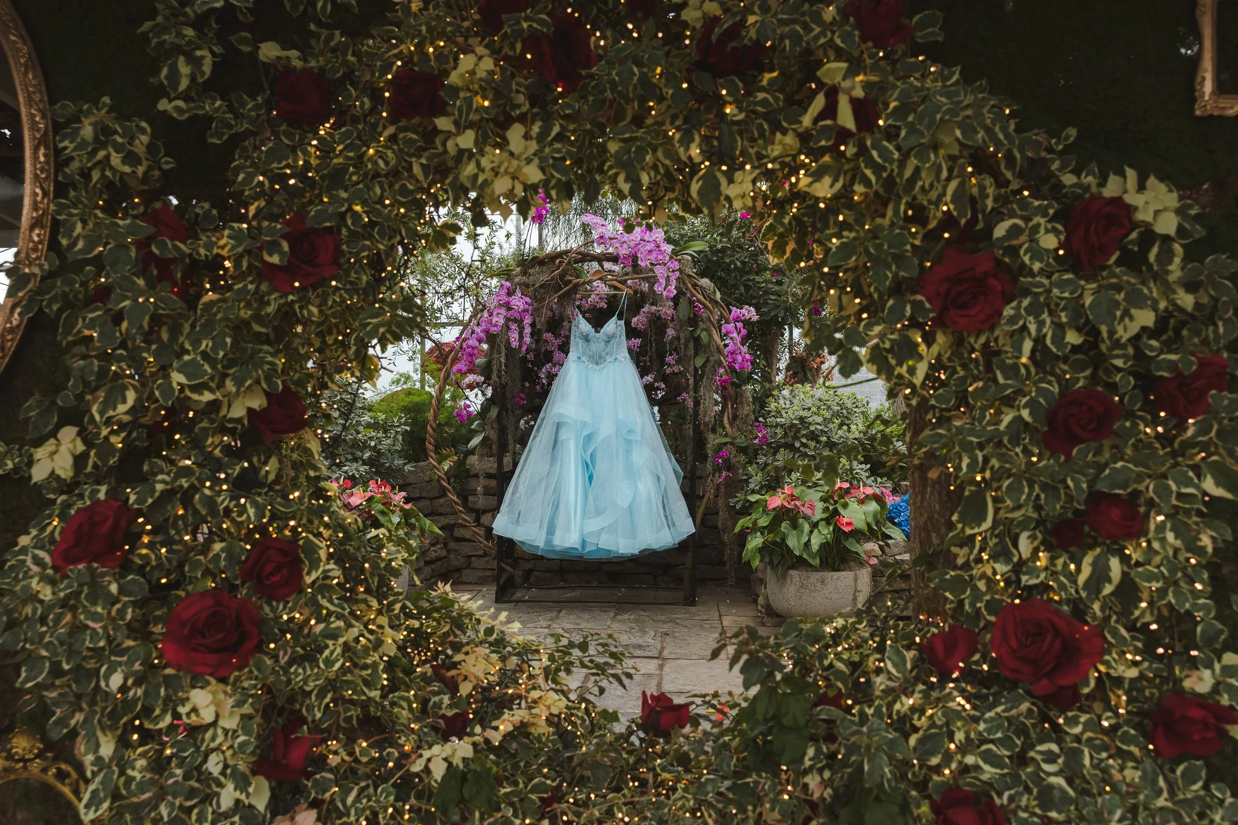 blue-wedding-dress-surronded-by-plants-and-rose-bush-alice-in-bloomland-fedora-media.jpg