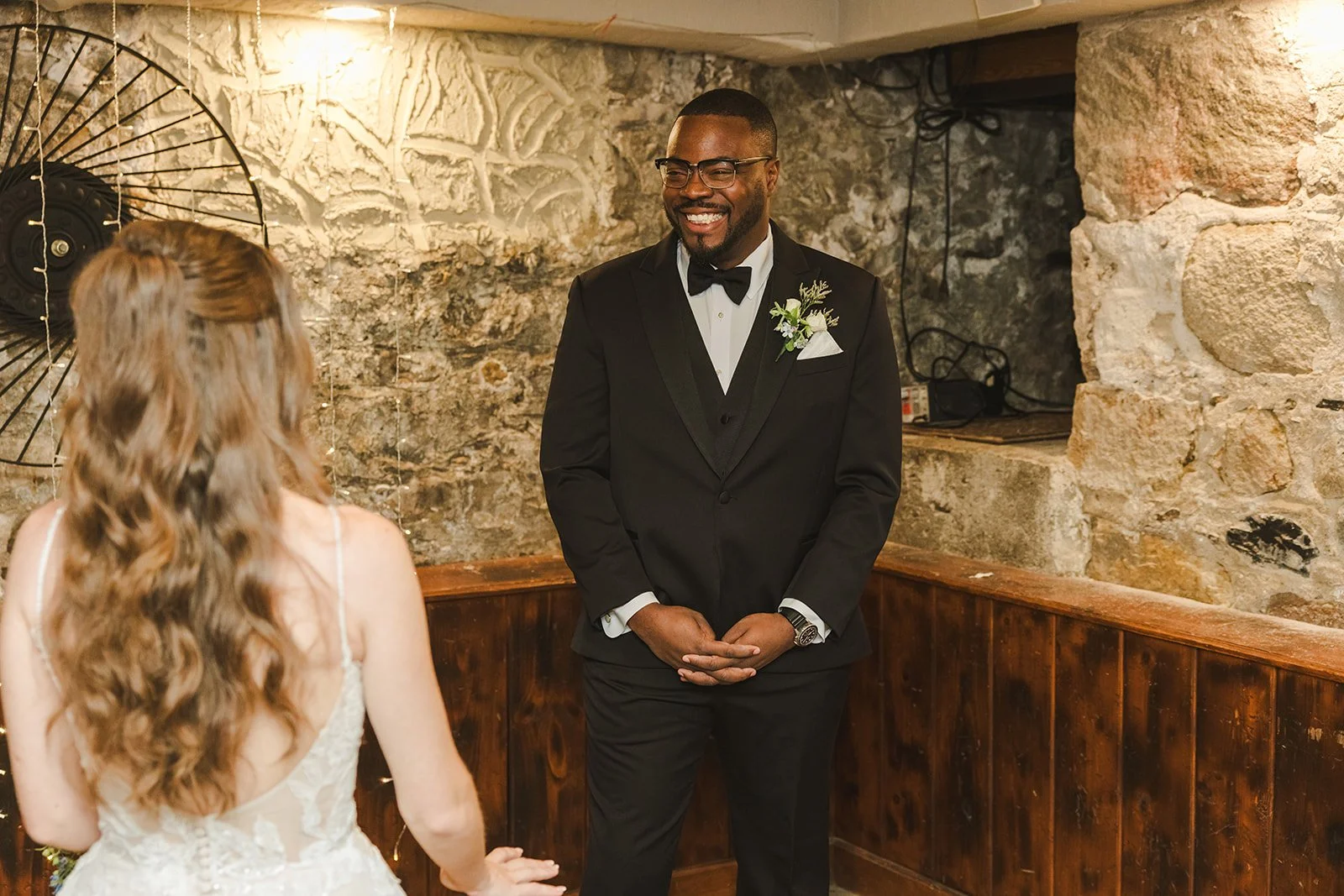 Groom smiling at bride wine cellar  River's Edge  Arlington Hotel  Paris, ON  Fedora Media.jpg