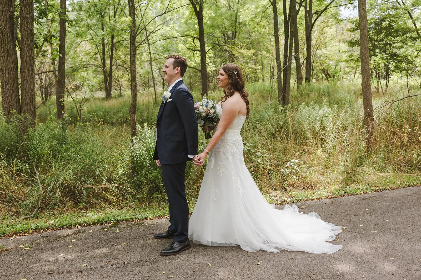 Bride and Groom hold hands during first look before he turns around to look at her  Carmen's Hotel  Hamilton, ON  Fedora Media.jpg