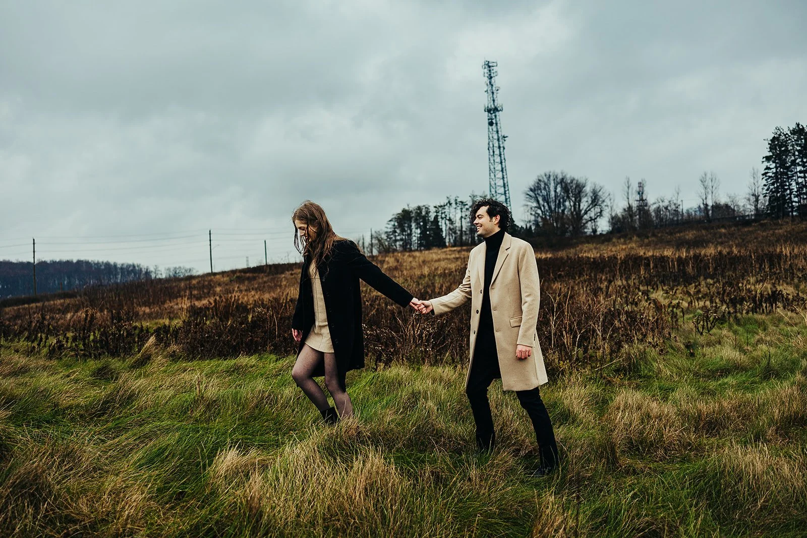 Engaged couple walking through field  Fedora Media.jpg