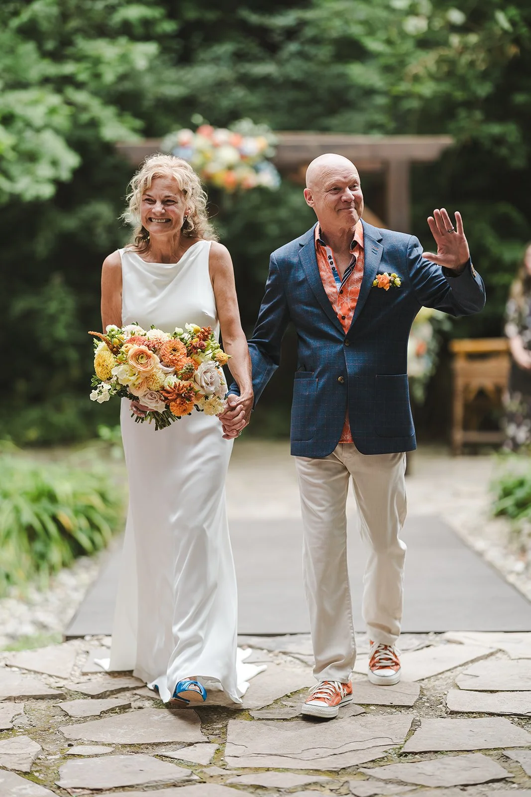 Bride and groom walking hand in hand down aisle  Erin Estates  Fedora Media.jpg