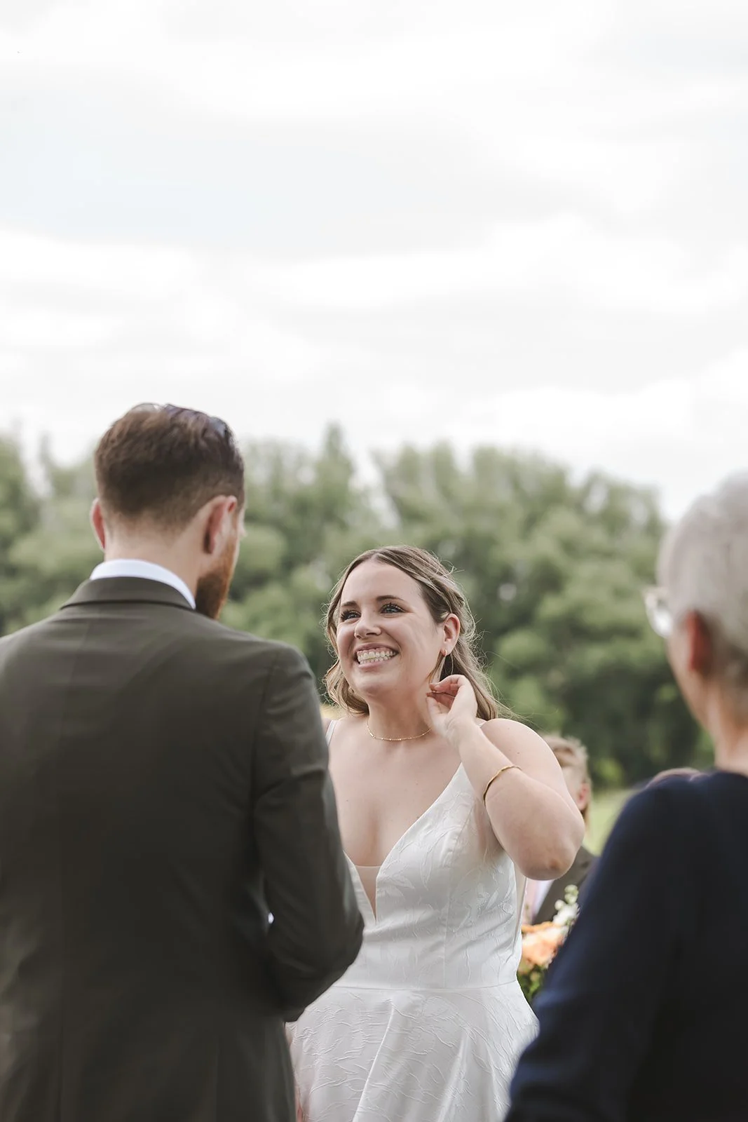 Bride smiling during ceremony  London, ON  Backyard Wedding  Fedora Media.jpg