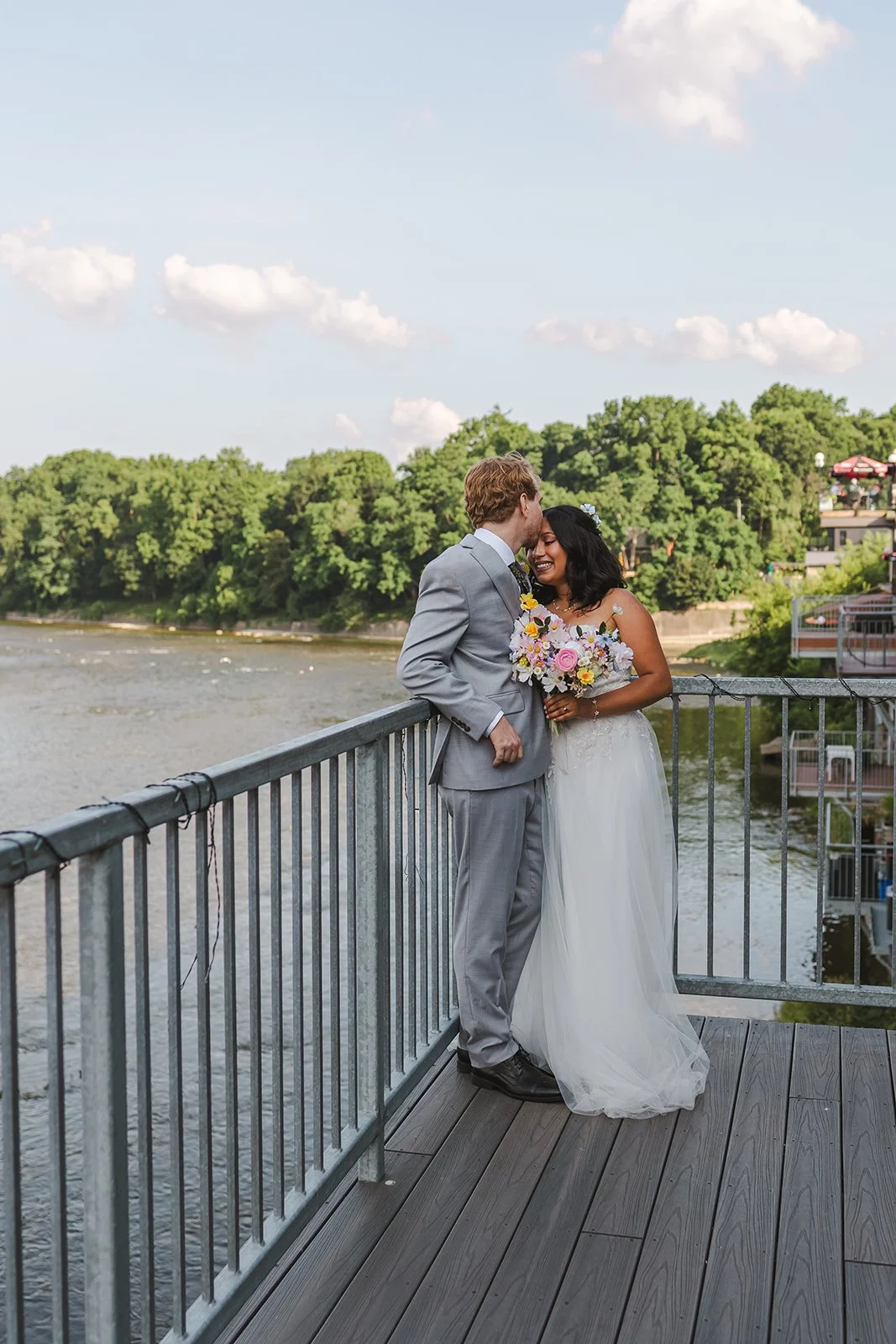 Groom kissing bride's forehead on balcony  River's Edge  Arlington Hotel  Paris, ON  Fedora Media.jpg