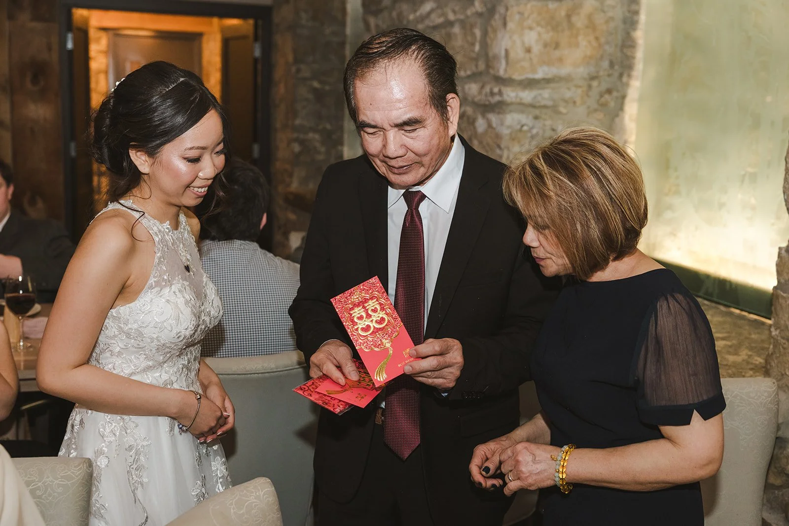 Bride receiving red envelope from parents in traditional ceremony  Cambridge,  ON  Cambridge Mill  Fedora Media.jpg
