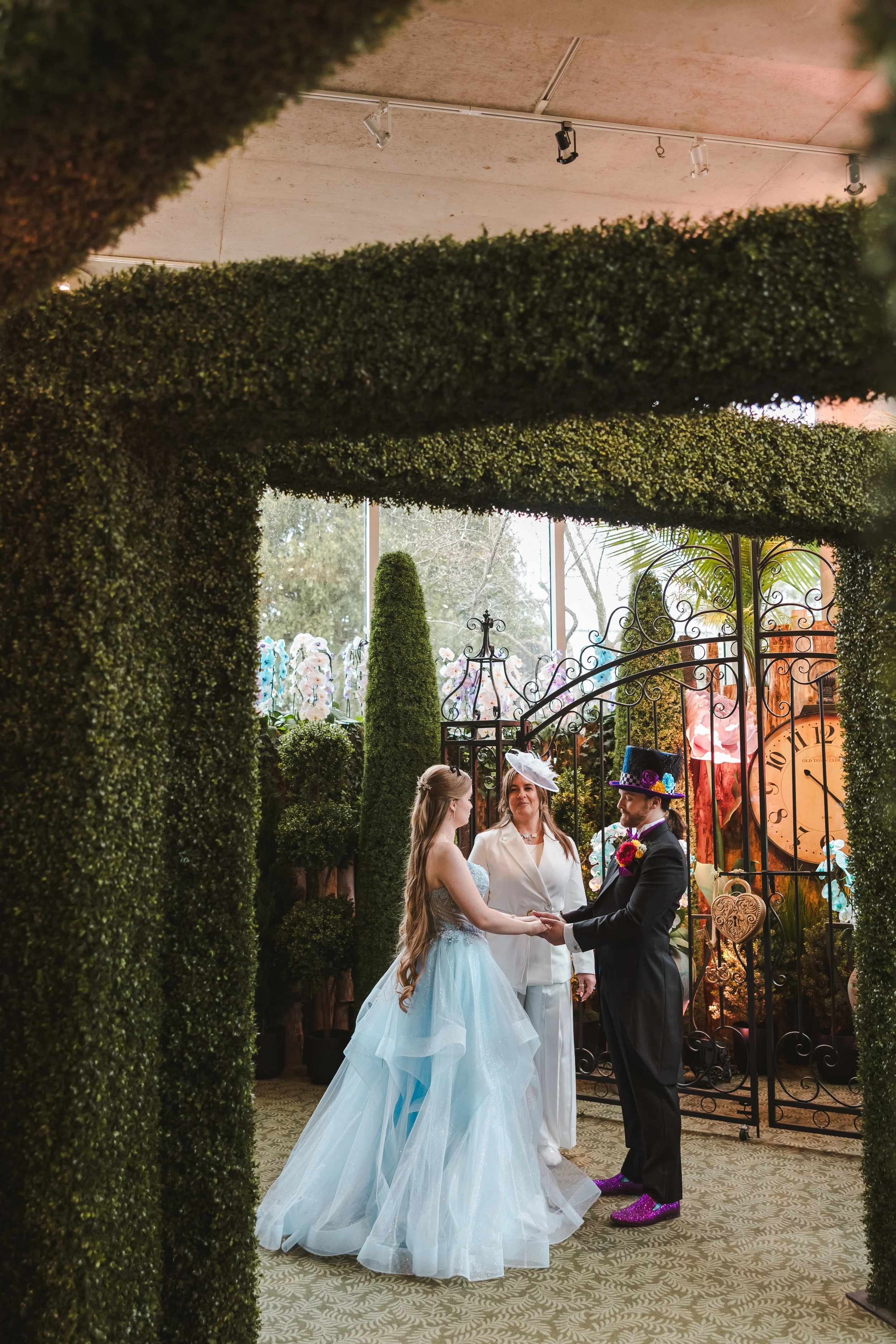 woman-in-blue-and-man-with-tophat-and-officiant-alice-in-bloomland-fedora-media.jpg