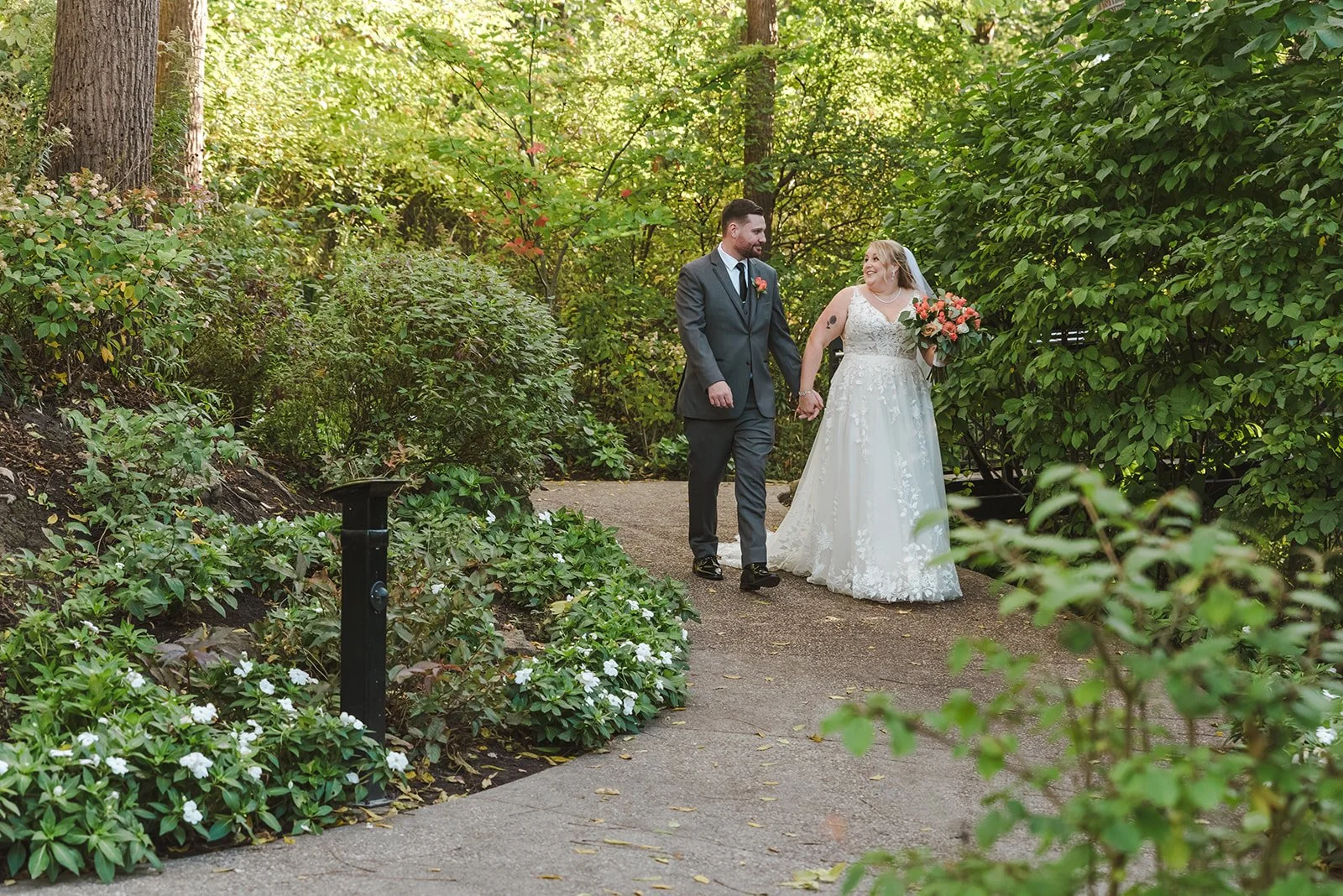 Bride and groom walking down path together  Ancaster,  ON  Ancaster Mill  Fedora Media.jpg