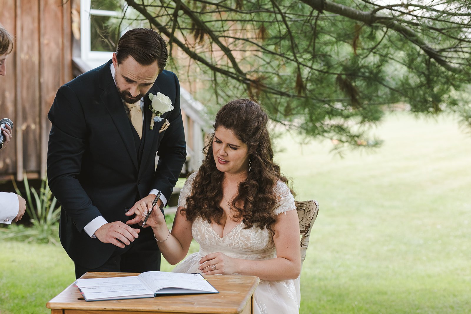 Bride and groom signing wedding certificate  CJ Country events  Guelph, ON  Fedora Media.jpg