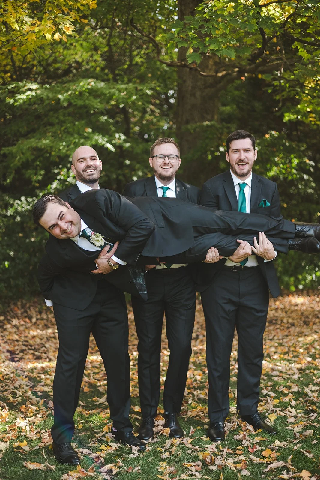 Groomsmen holding groom in the air  Erin Estates  Fedora Media.jpg
