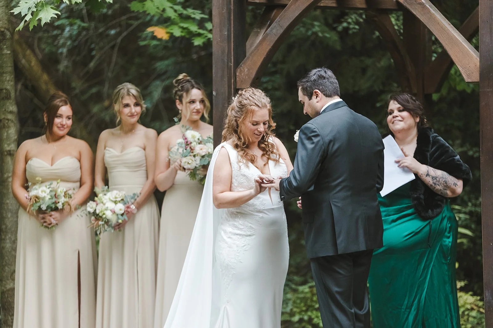 Bride placing grooms ring on finger  Erin Estates  Fedora Media.jpg