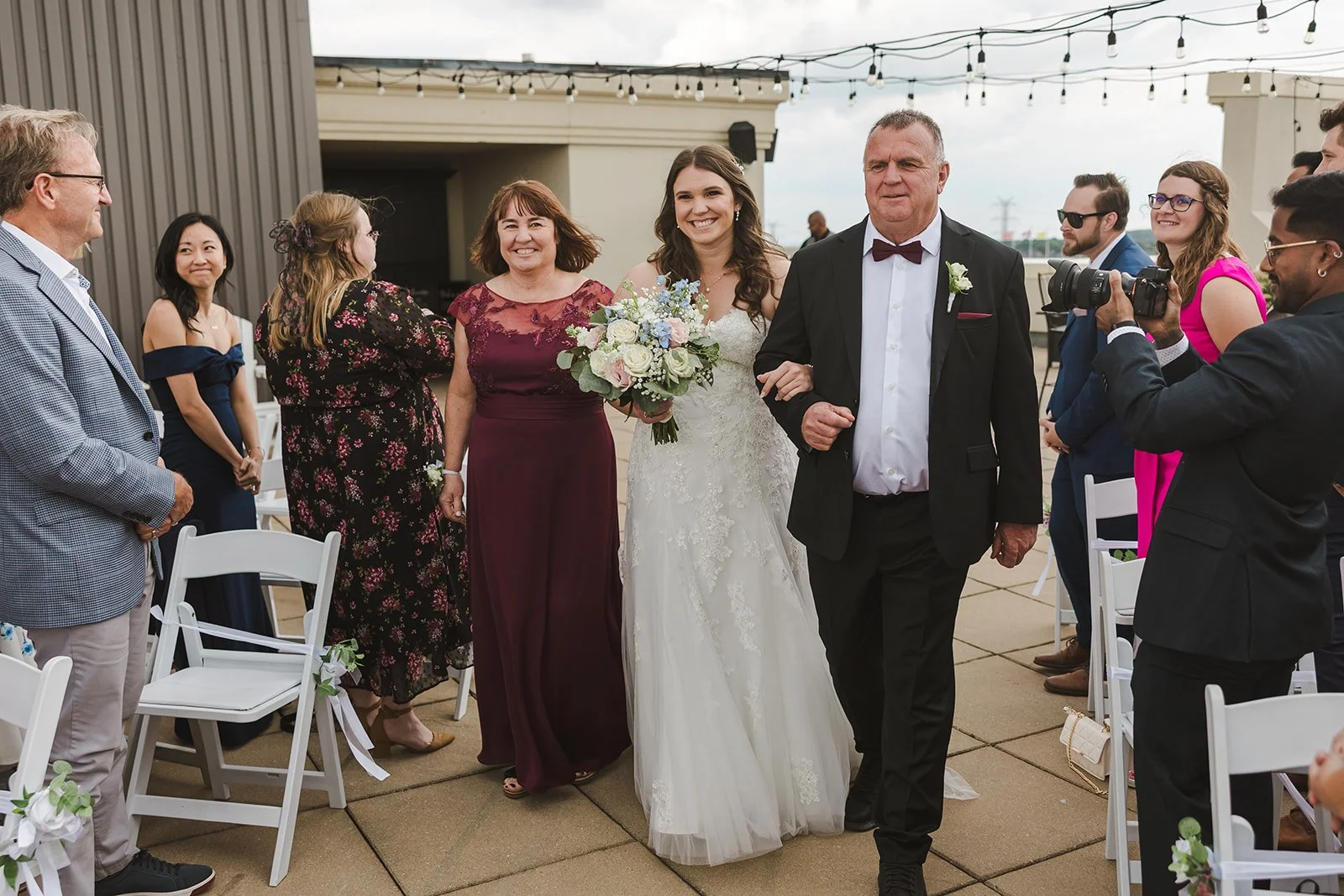 Bride walking down aisle with parents  Carmen's Hotel  Hamilton, ON  Fedora Media.jpg