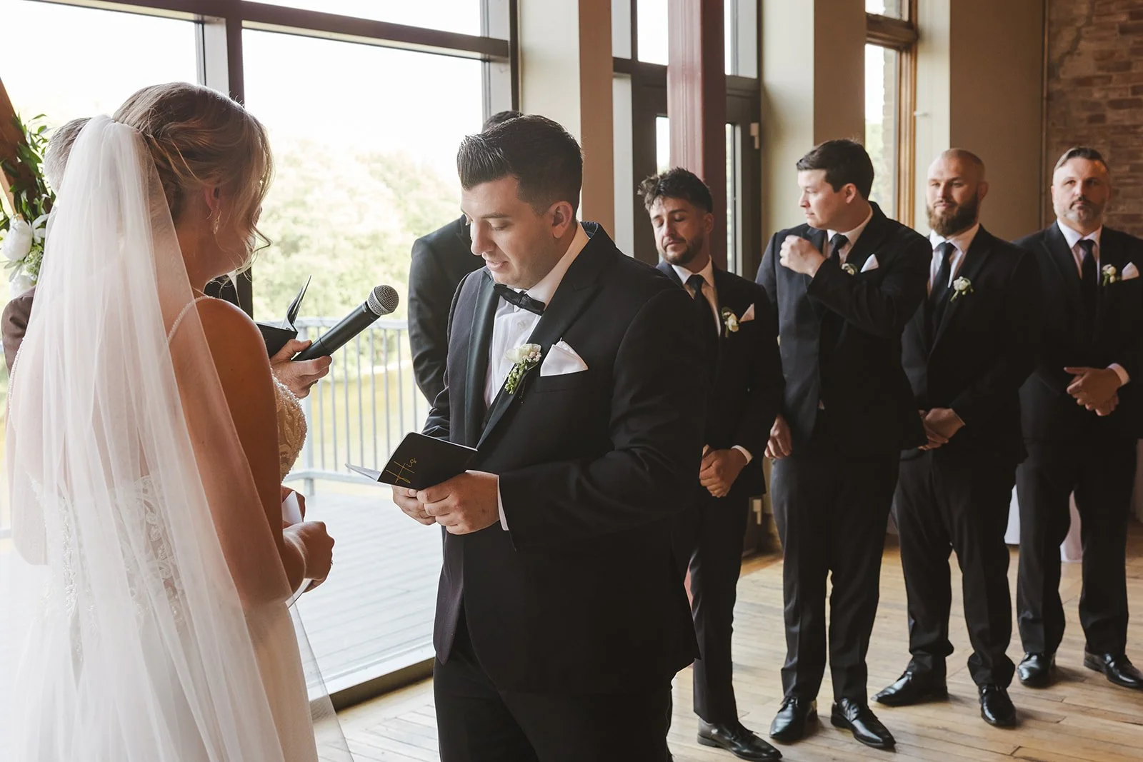 Groom reading vows during wedding ceremony  Arlington Hotel  River's Edge  Paris, ON  Fedora media.jpg