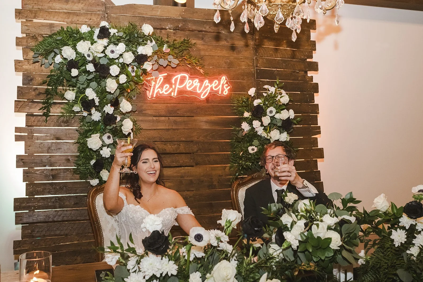 Bride and groom at head table with raised glasses  Erin Estates  Fedora Media.jpg